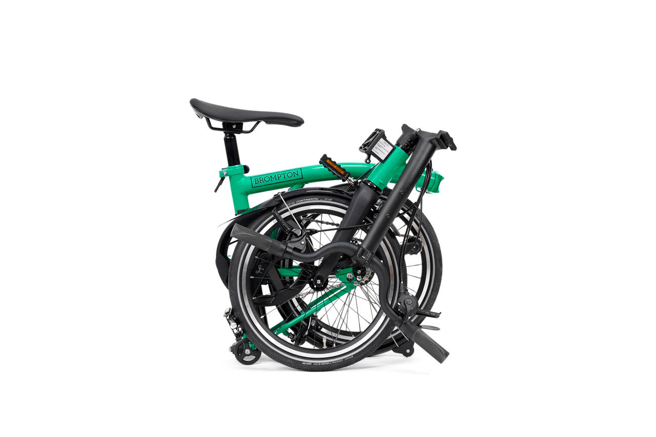 Green and black folding bicycle on a white background