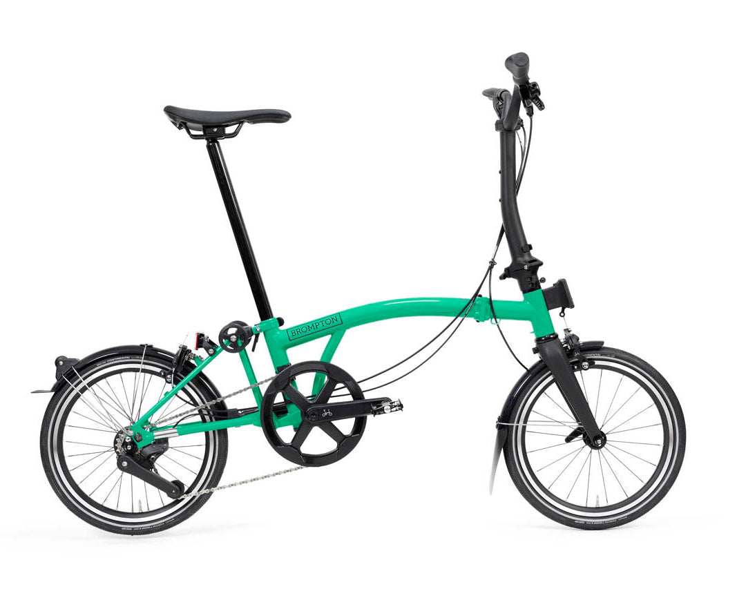 Green Brompton P Line folding bicycle on a white background