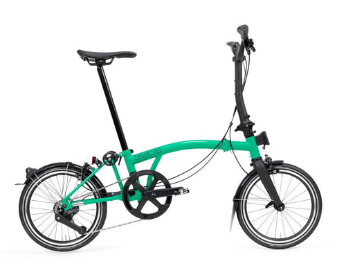 Green Brompton P Line folding bicycle on a white background
