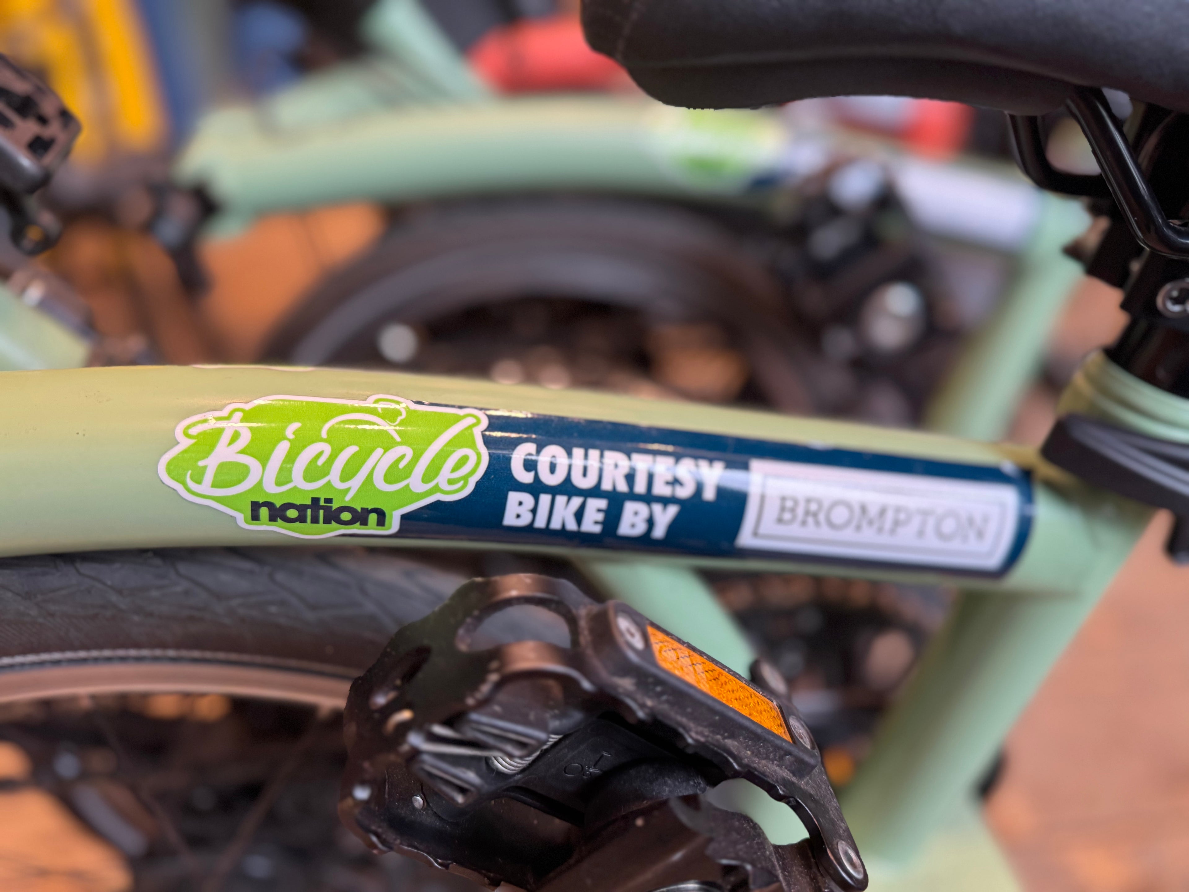 Bicycle frame with a 'Bicyclenation' and 'Brompton' sticker