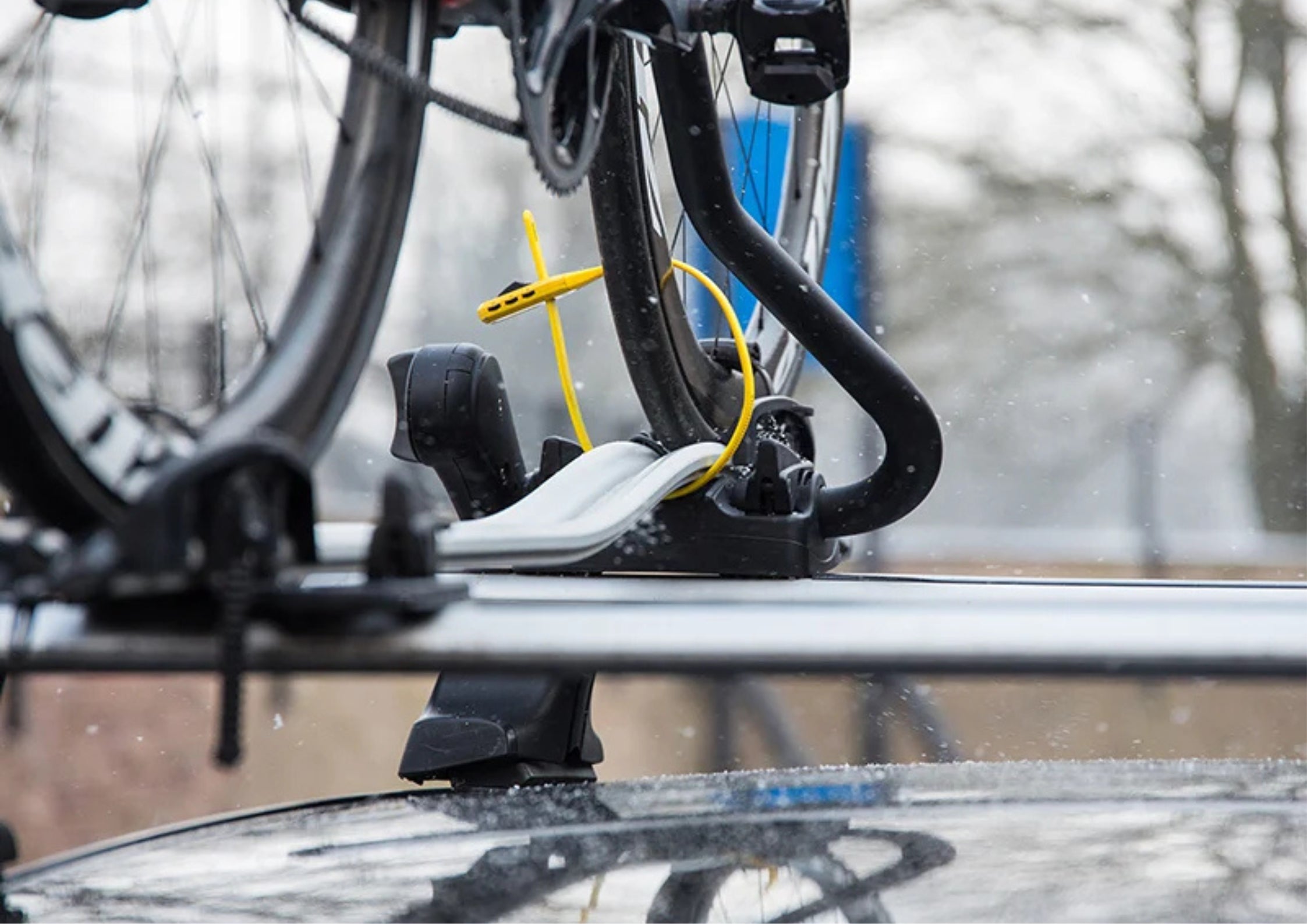 Bicycle mounted on a car roof rack with a blurred background