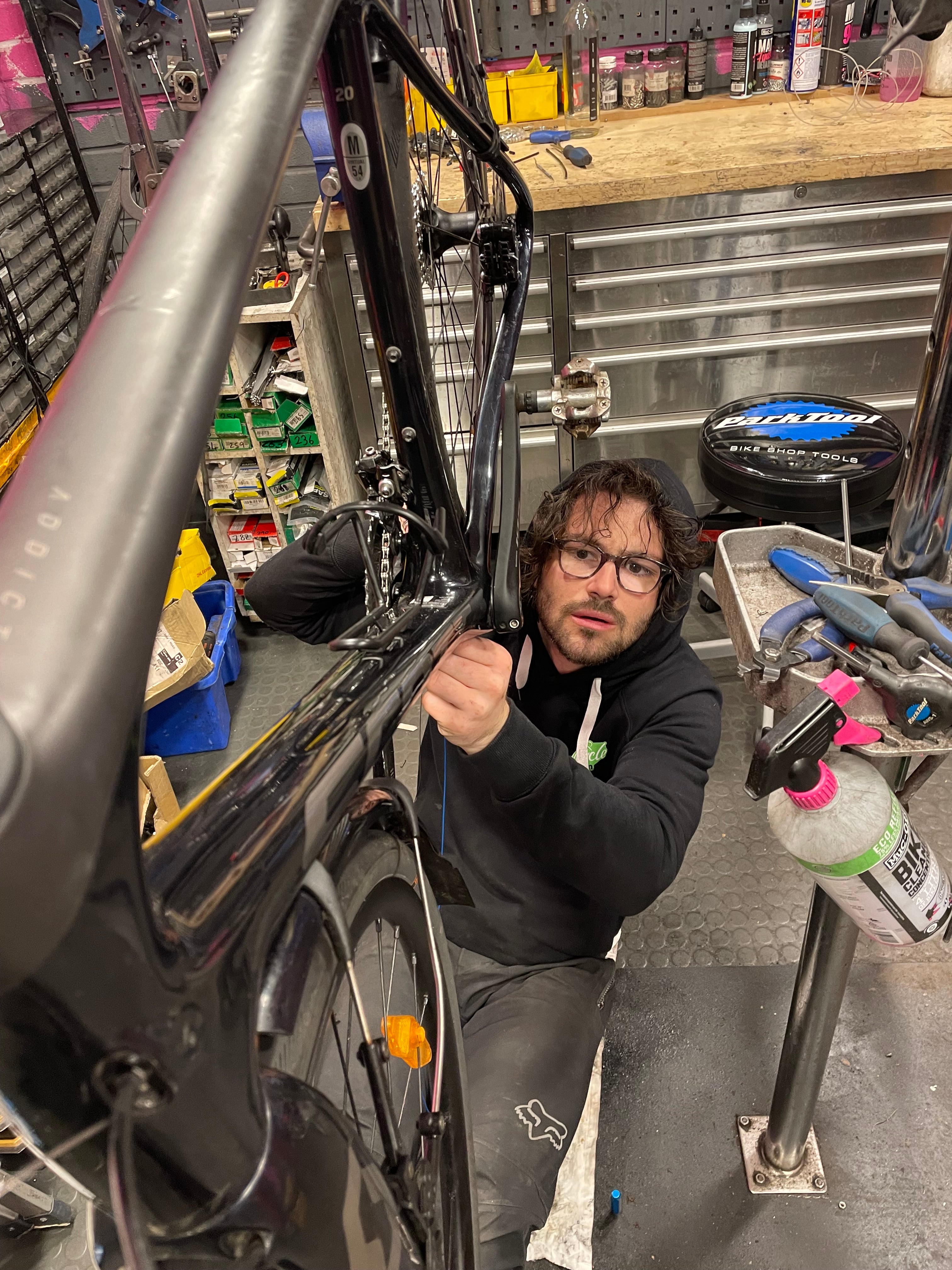 Person working on a bike in a garage