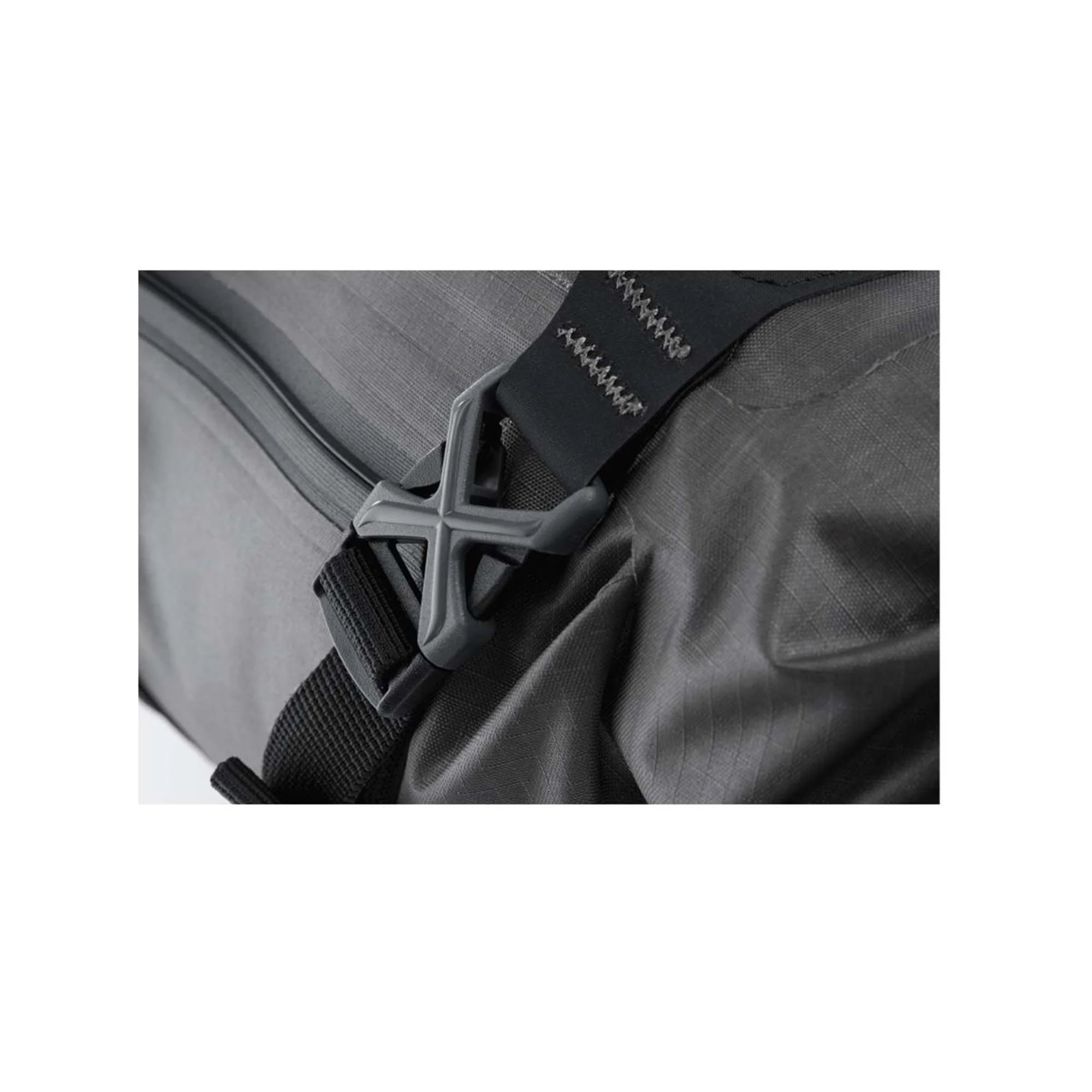 Gray bag with a black strap and visible brand logo on a white background