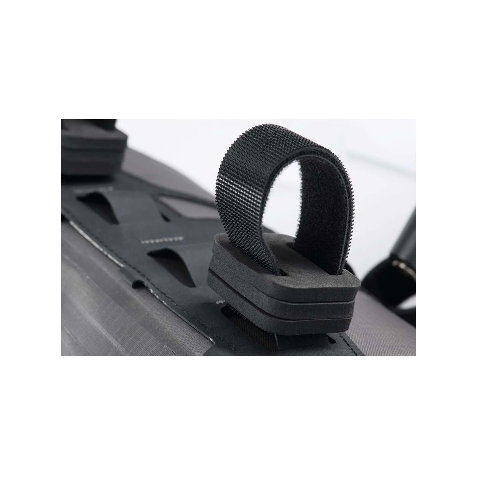 Black strap or buckle on a metallic surface with a blurred background