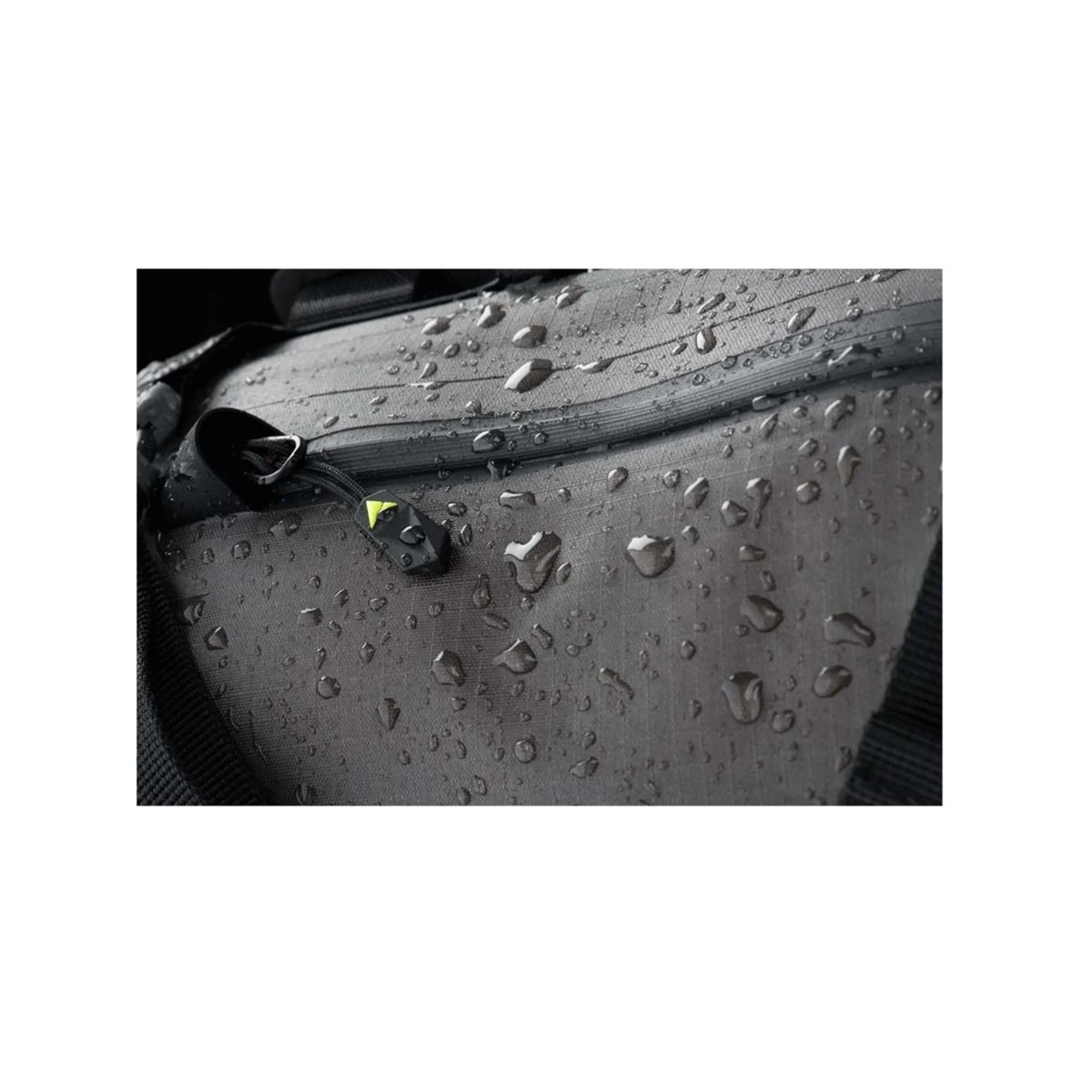 Close-up of a pannier bag with water droplets on a white background