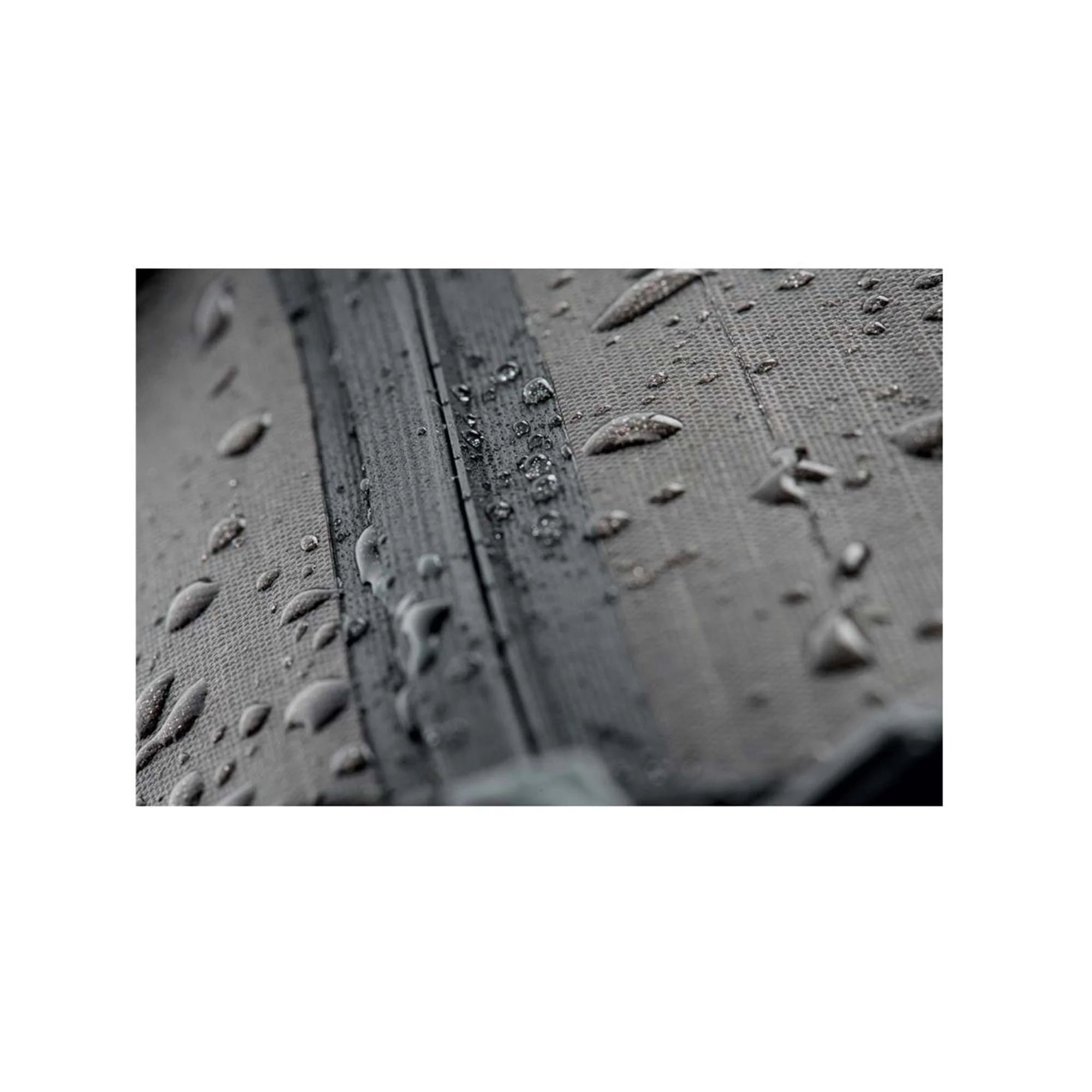 Close-up of a textured surface with water droplets on a white background