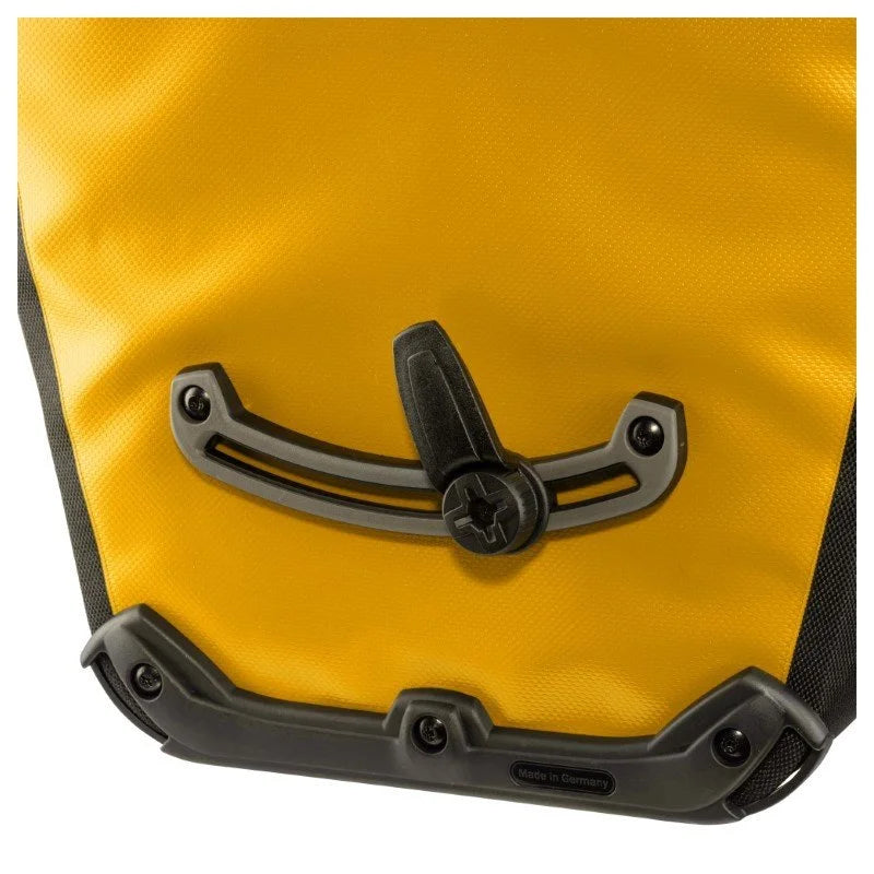 Yellow pannier bag with black handle and hardware on a white background