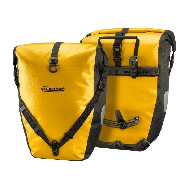 Two yellow pannier bags with black straps on a white background
