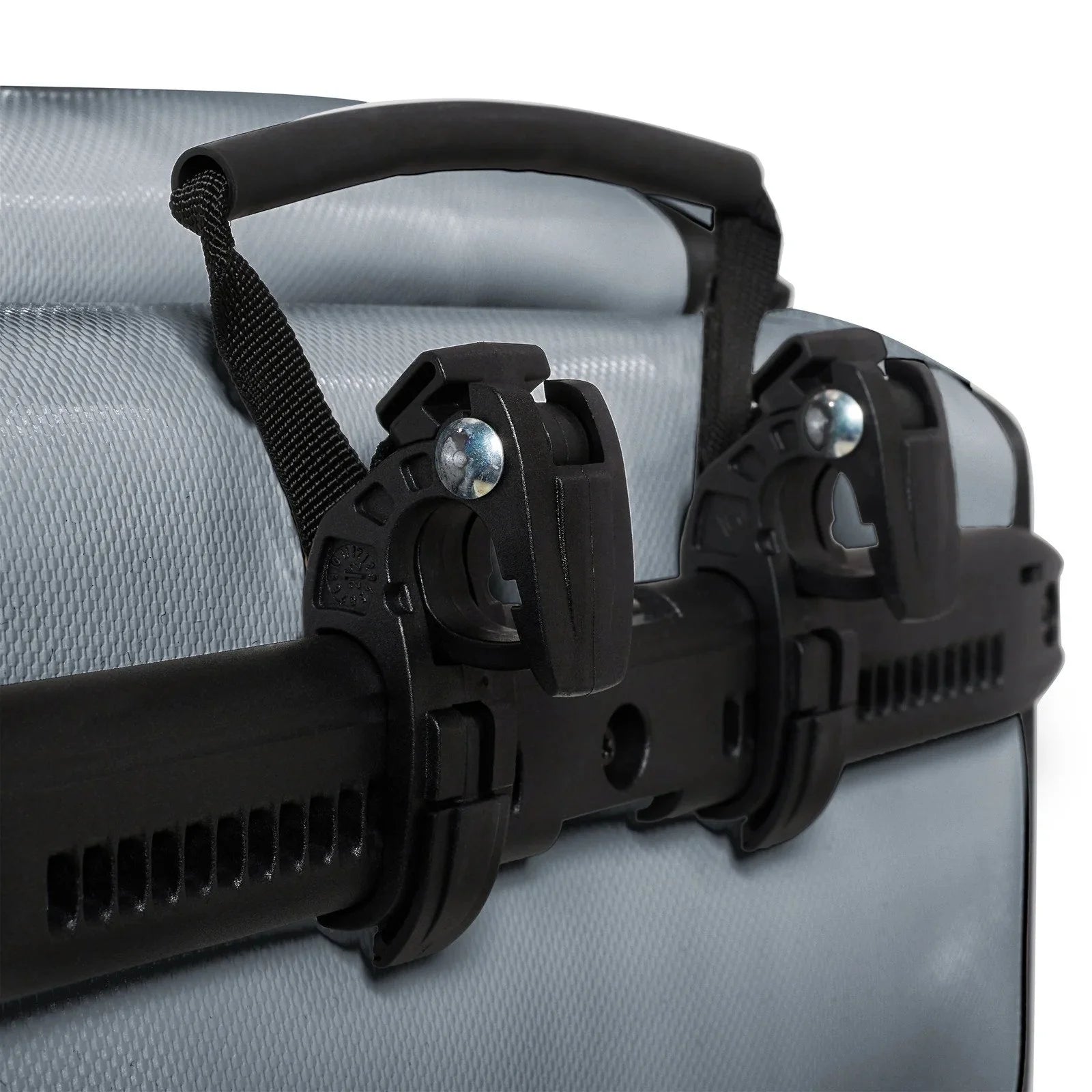 Close-up of a bicycle pannier handle with a black plastic bracket on a light gray background
