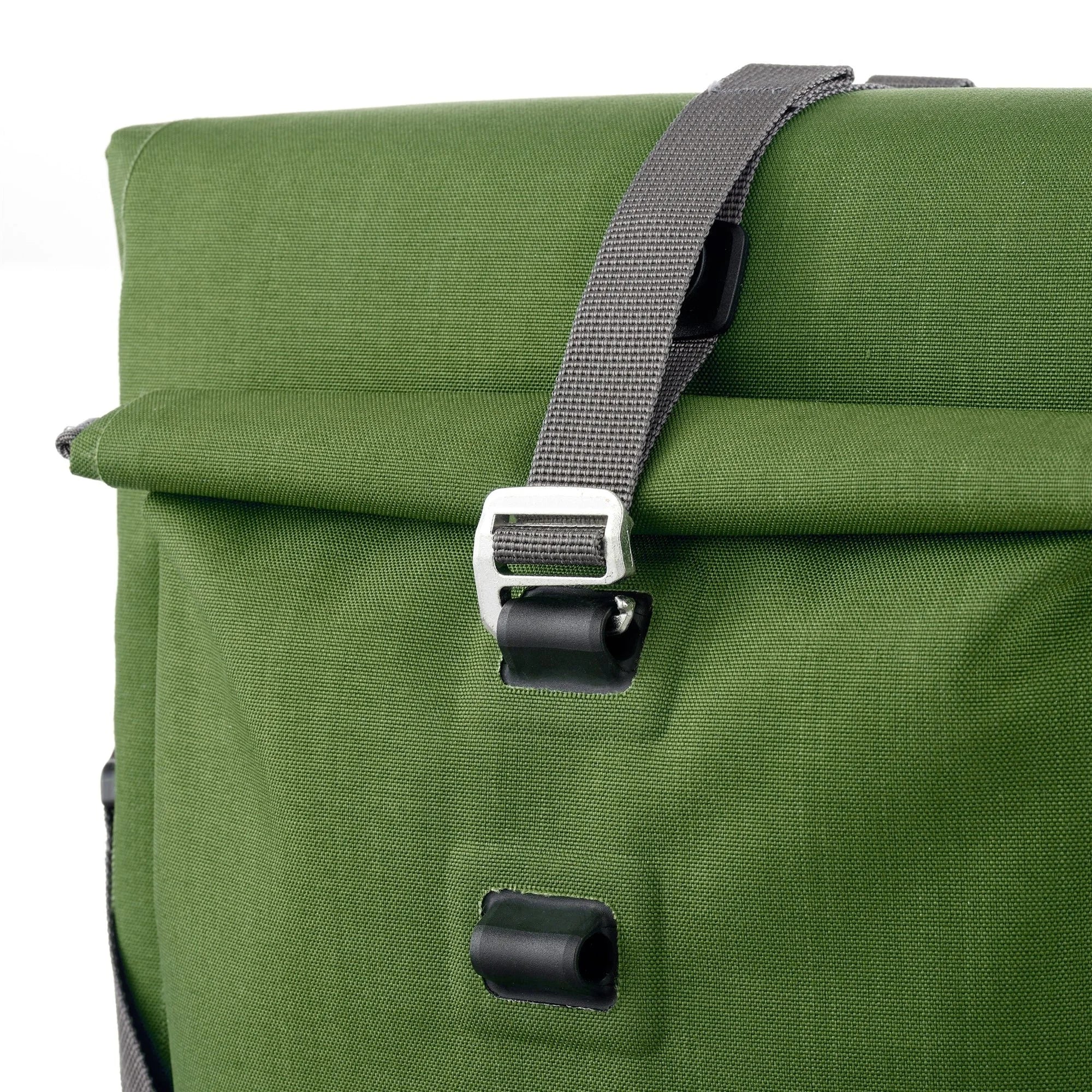 Green pannier bag with a buckle on a white background