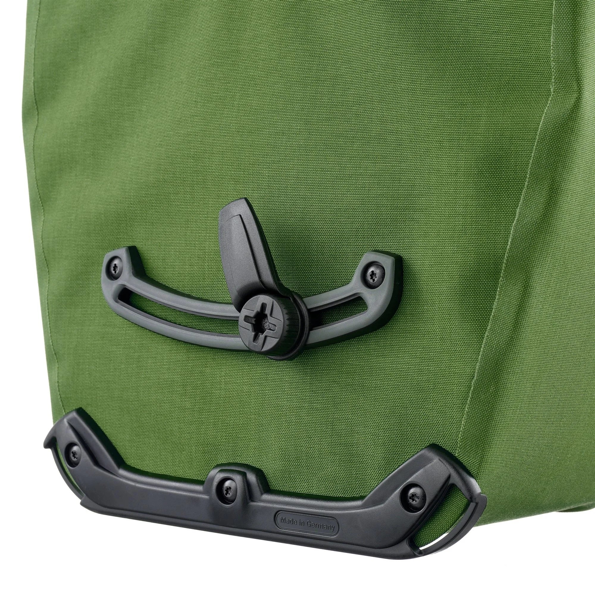 Close-up of a green bag with black metal clasp on a white background
