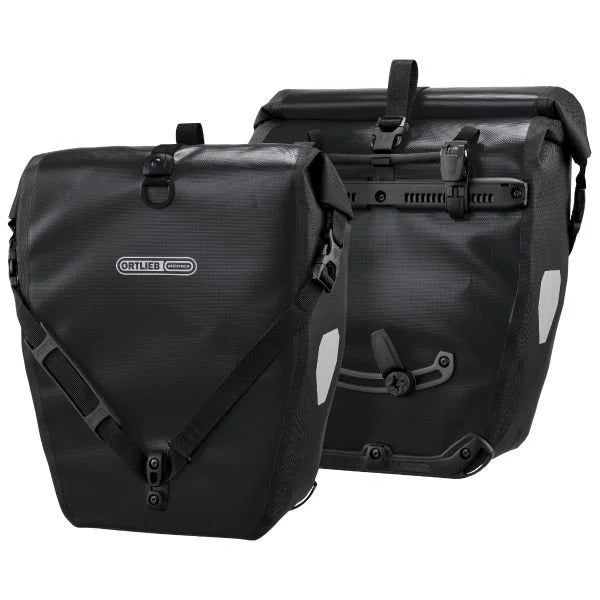 Two black Ortlieb bags on a white background