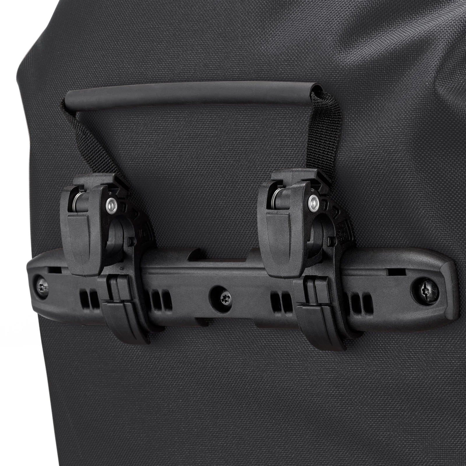 Close-up of a black bag with a handle and straps on a gray background