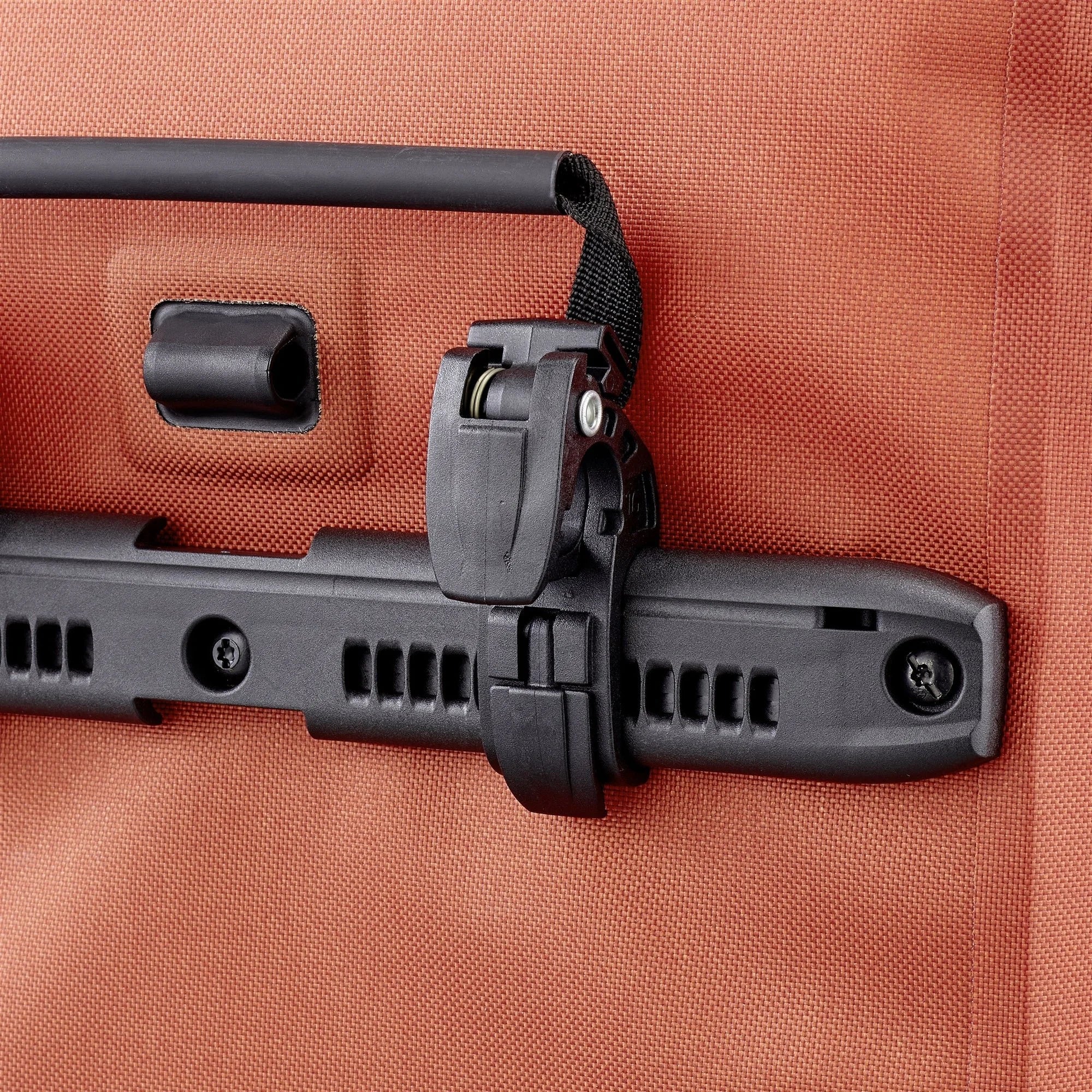 Close-up of an orange pannier's handle.