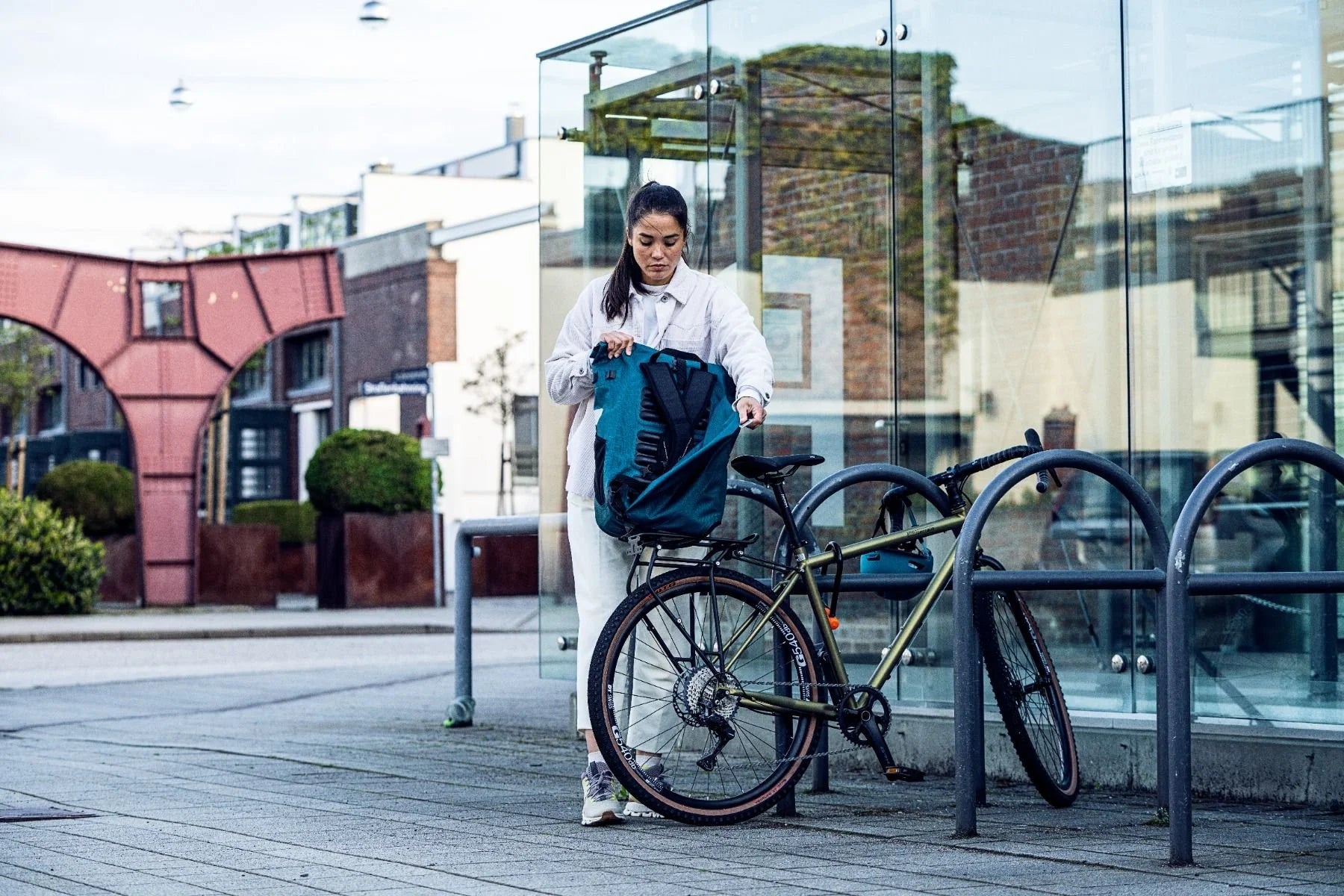 Woman with a bicycle in an urban setting