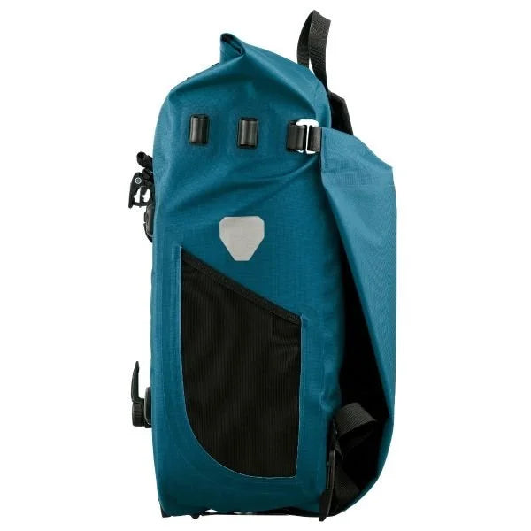 Teal bike pannier with a black compartment on a white background