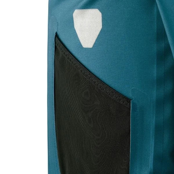 Close-up of a teal pannier with a black pocket and white logo on a white background