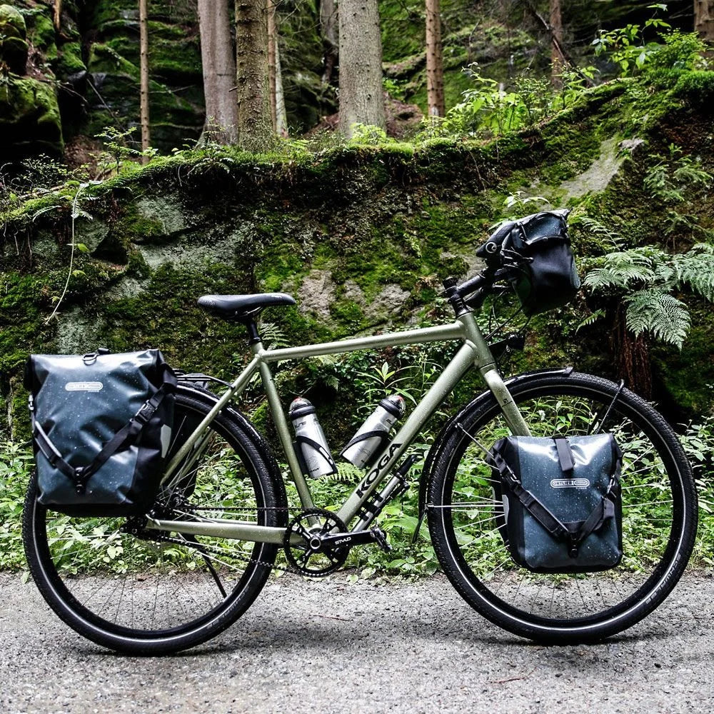 Bicycle with gear packs in a forest setting