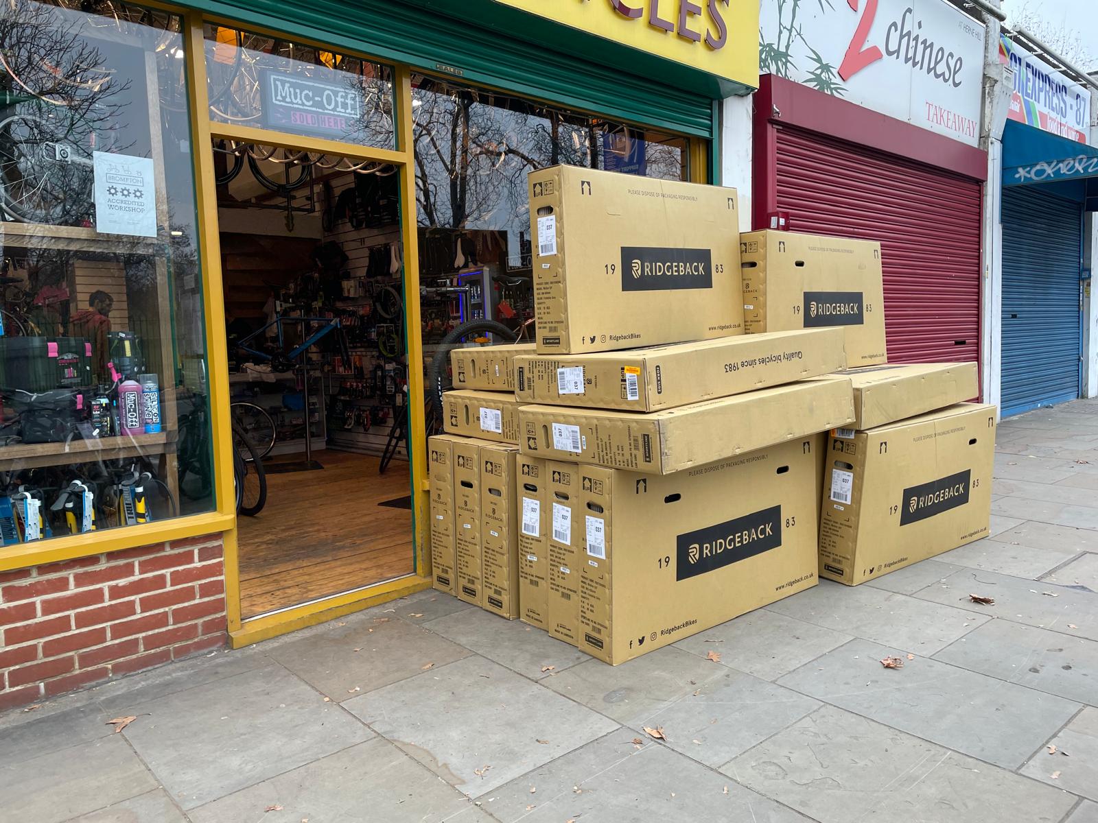 Stack of boxes with 'Ridgeline' branding in front of a store entrance.