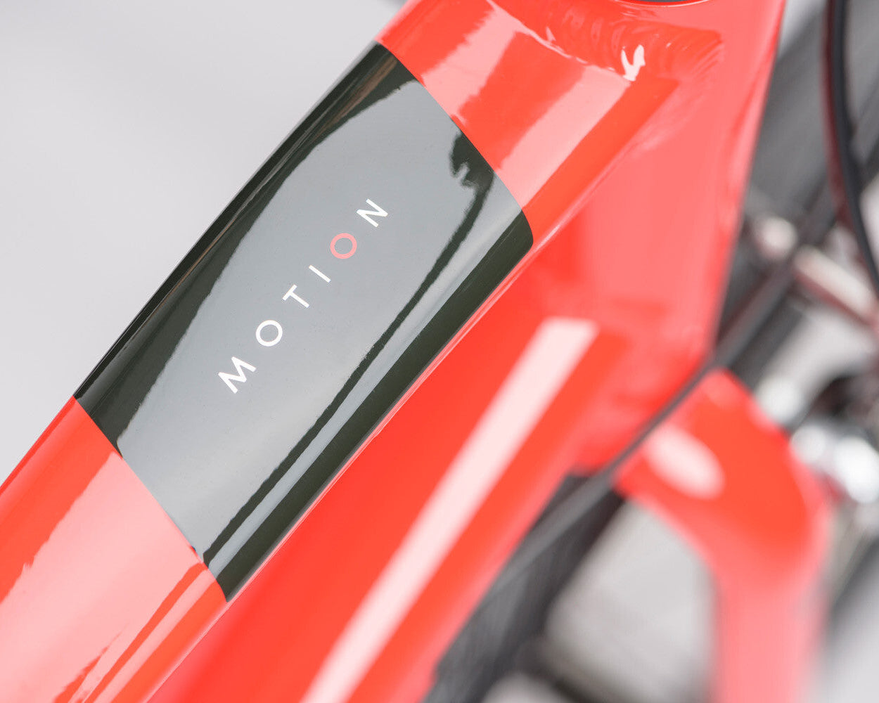 close up of a Ridgeback Motion bicycle frame on a blurred grey background.