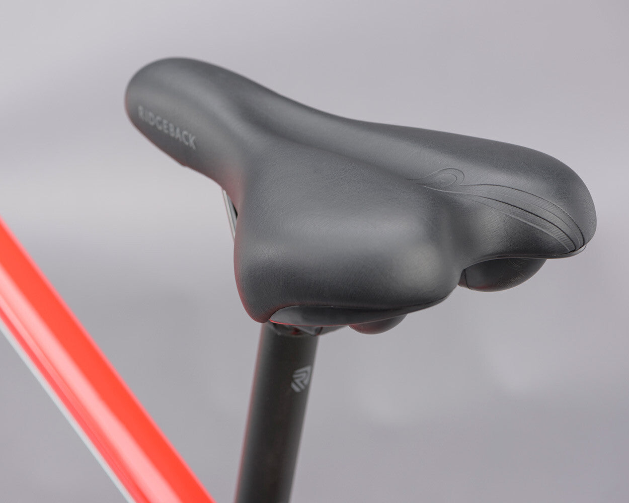 Close up of a bicycle saddle on a grey background