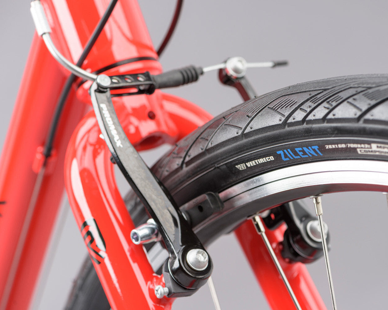 Close-up of a ridgeback motion bicycle tire with a brand name on a gray background
