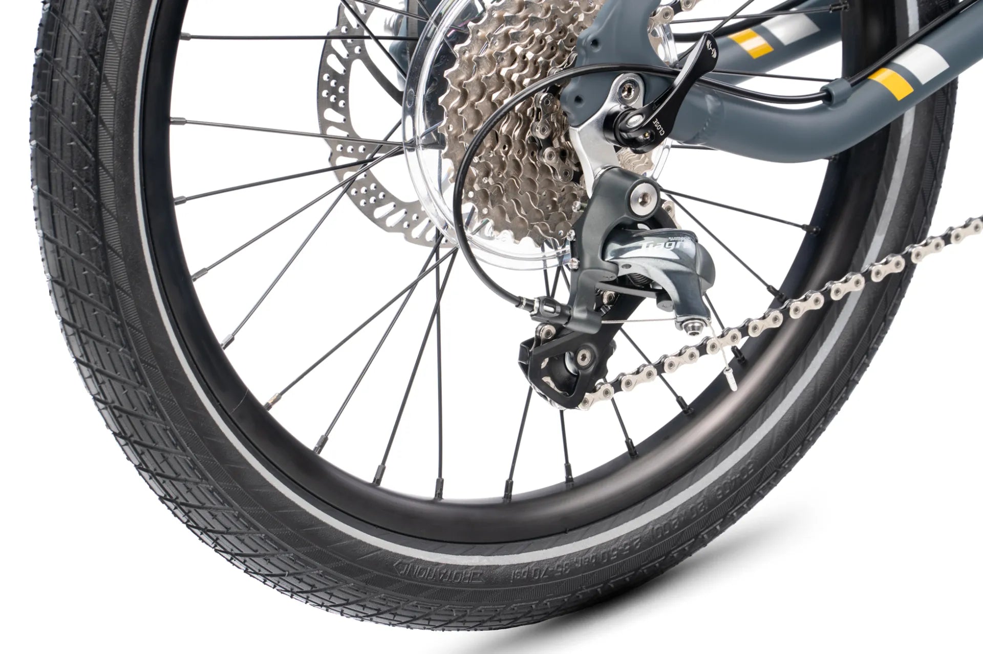 Close-up of a bicycle rear wheel with a black tire, silver disc brake rotor, multi-gear cassette, chain, and derailleur on a white background.