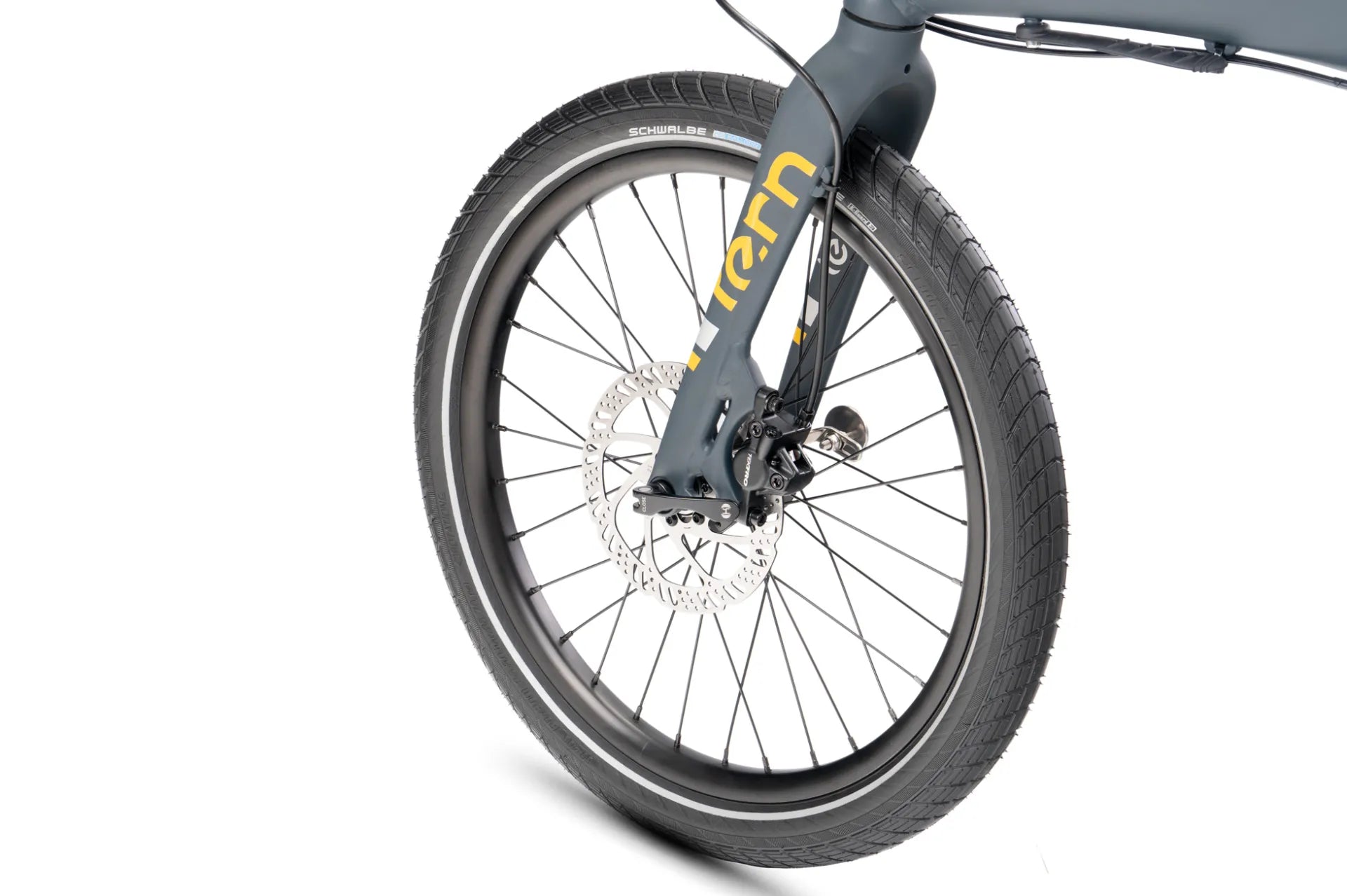 Close-up of a bicycle front wheel and fork on a white background, showing a dark gray frame with yellow lettering and a black tire.