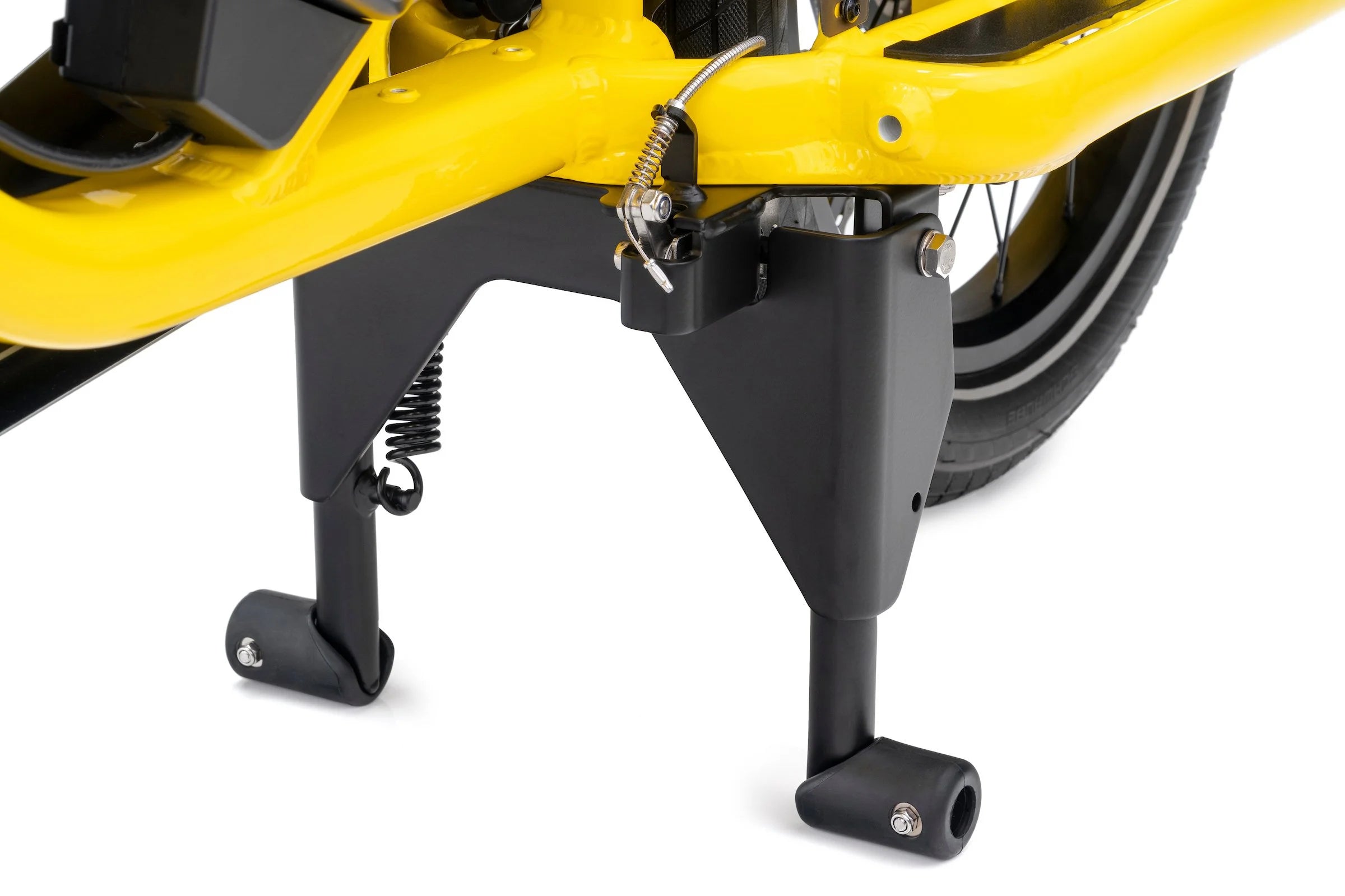 Close-up of a yellow bicycle with a black pedal and chain mechanism on a white background