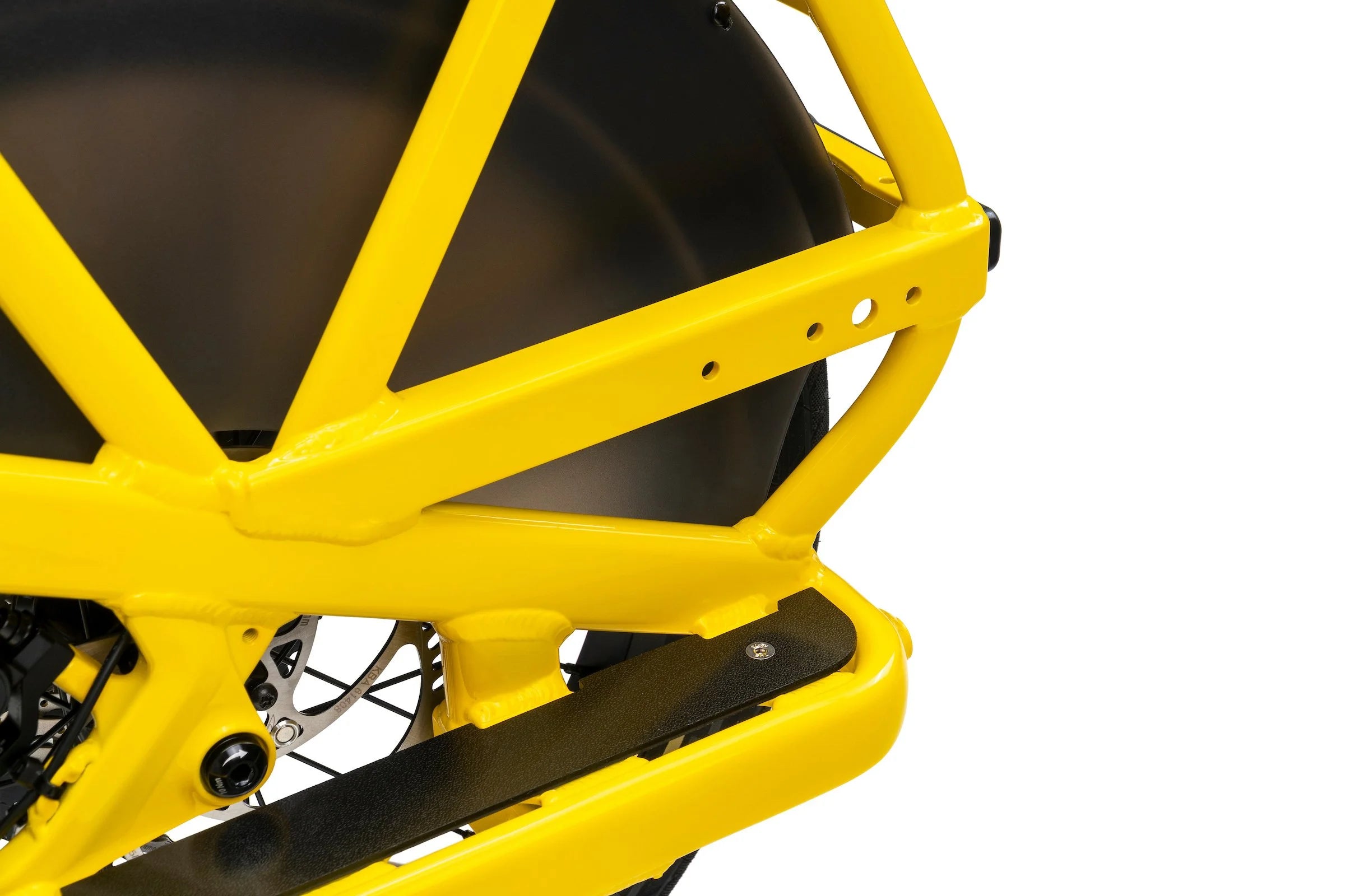 Close-up of a yellow cargo bike frame on a white background