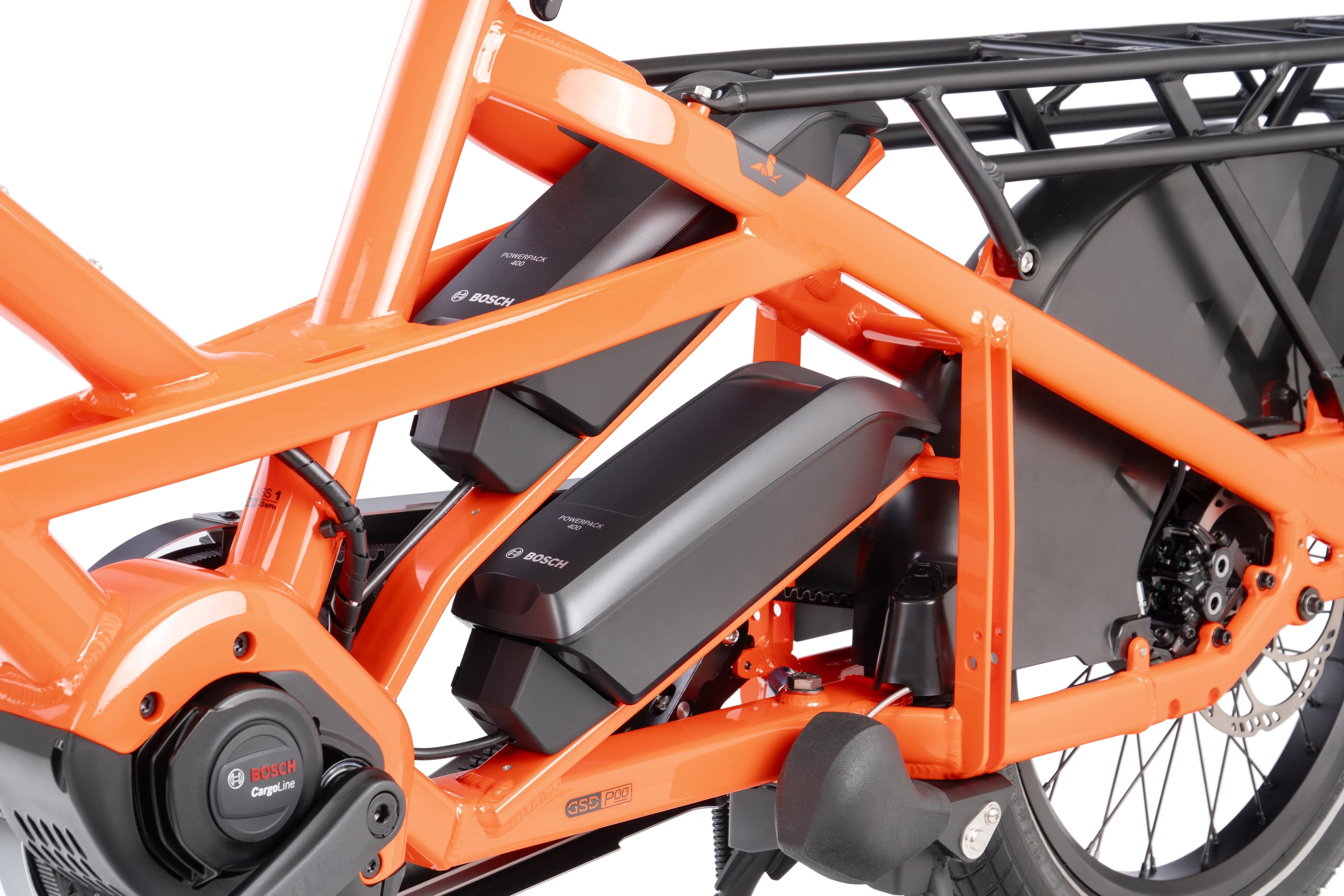 Close-up of an orange electric bike with a black battery pack and rack.