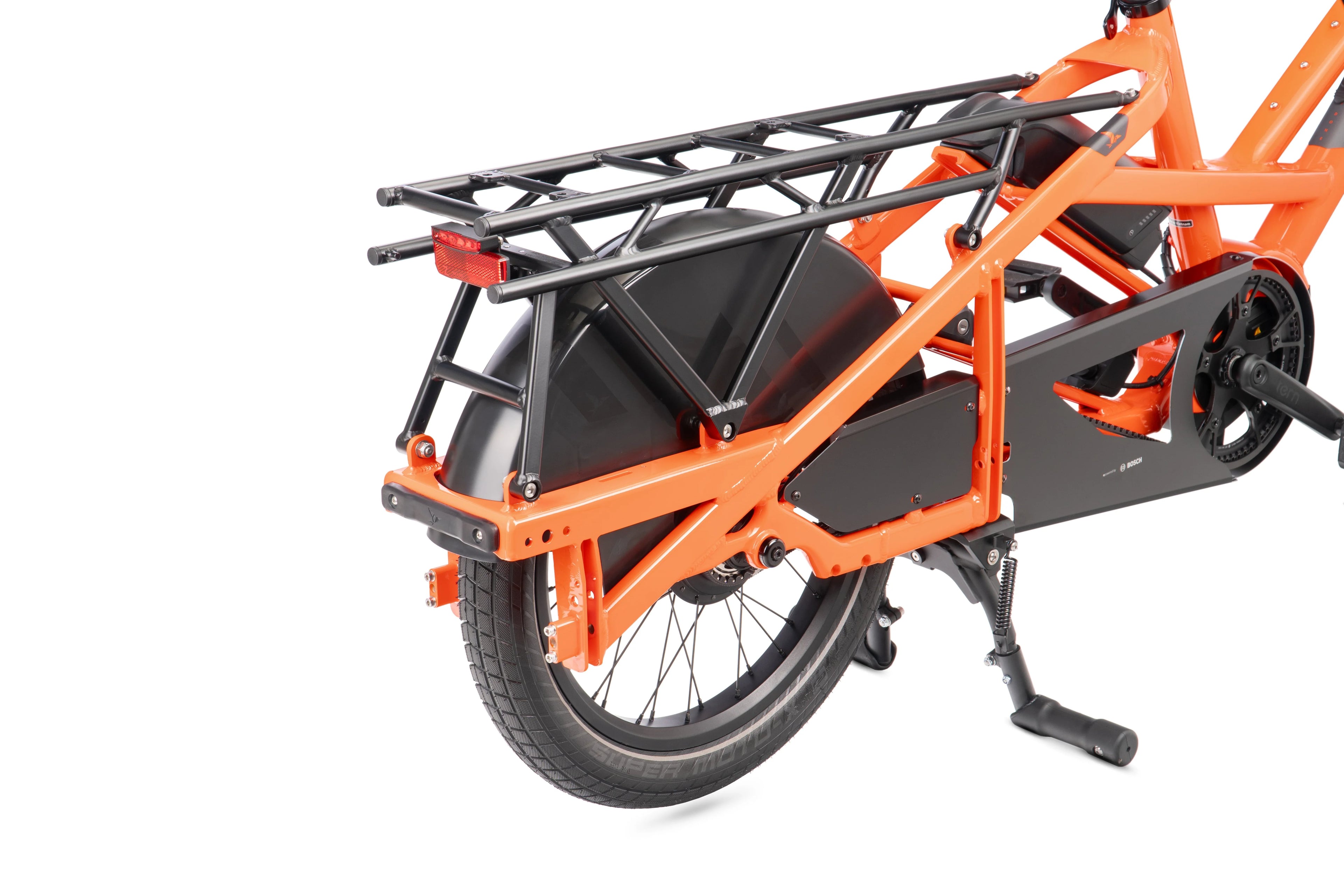 Orange cargo bike with a black rack on a white background