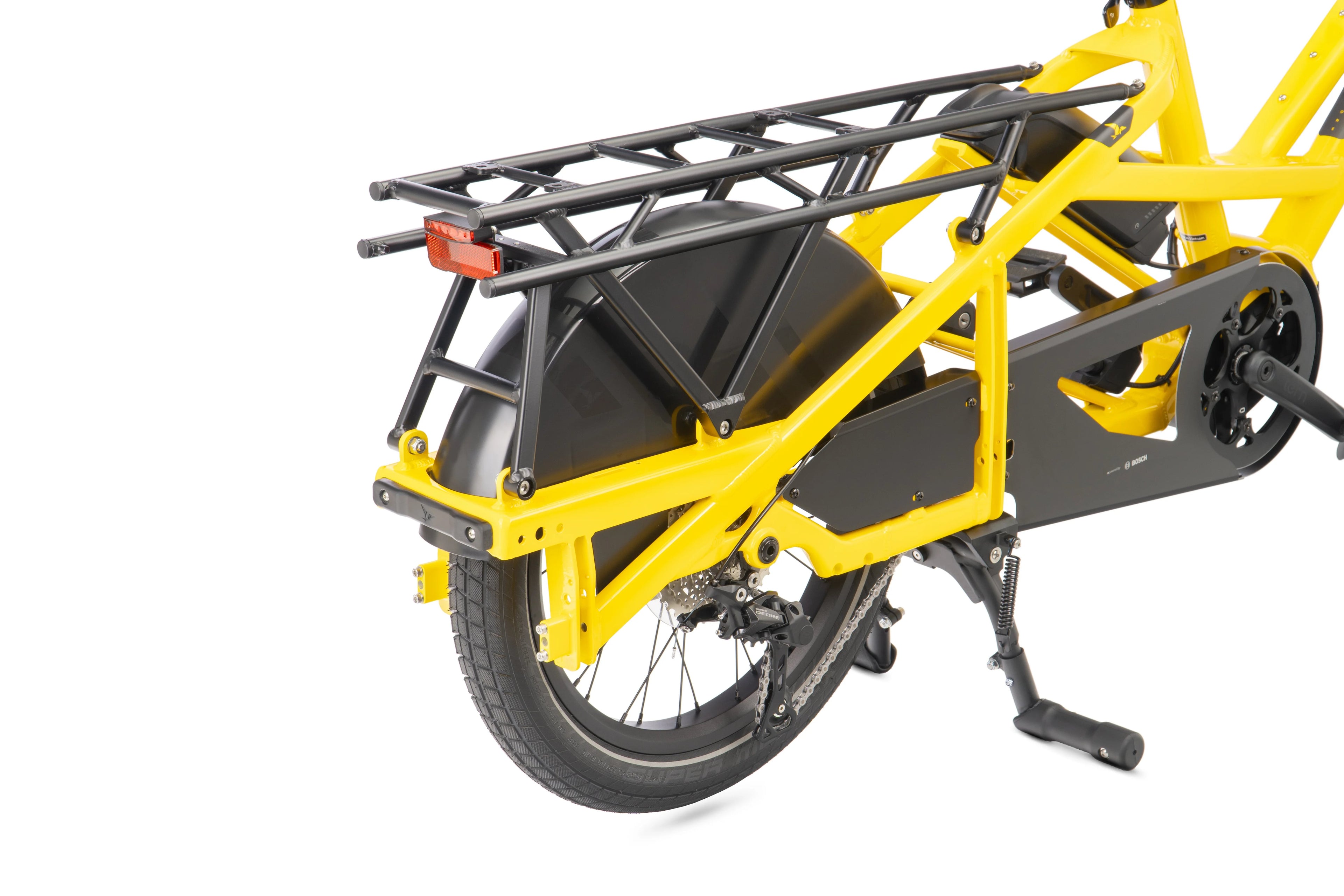 Yellow cargo bike with a black rack on a white background