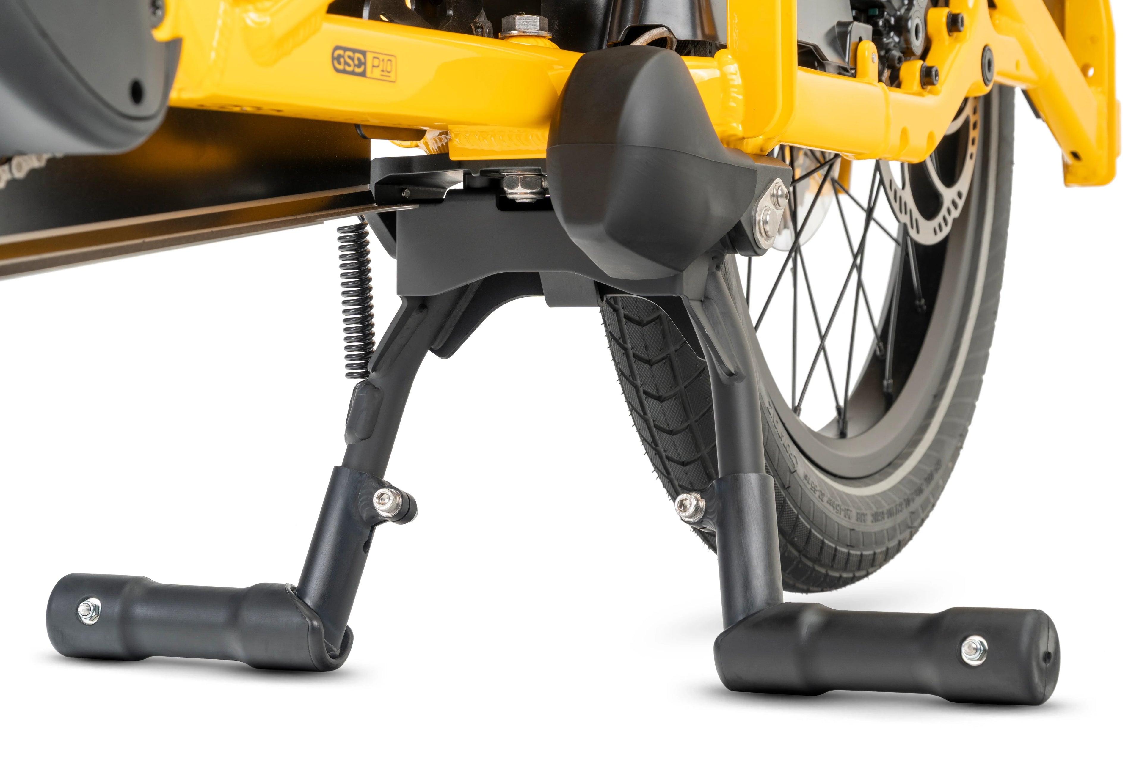 Close-up of a yellow and black electric bike with foot pegs on a white background