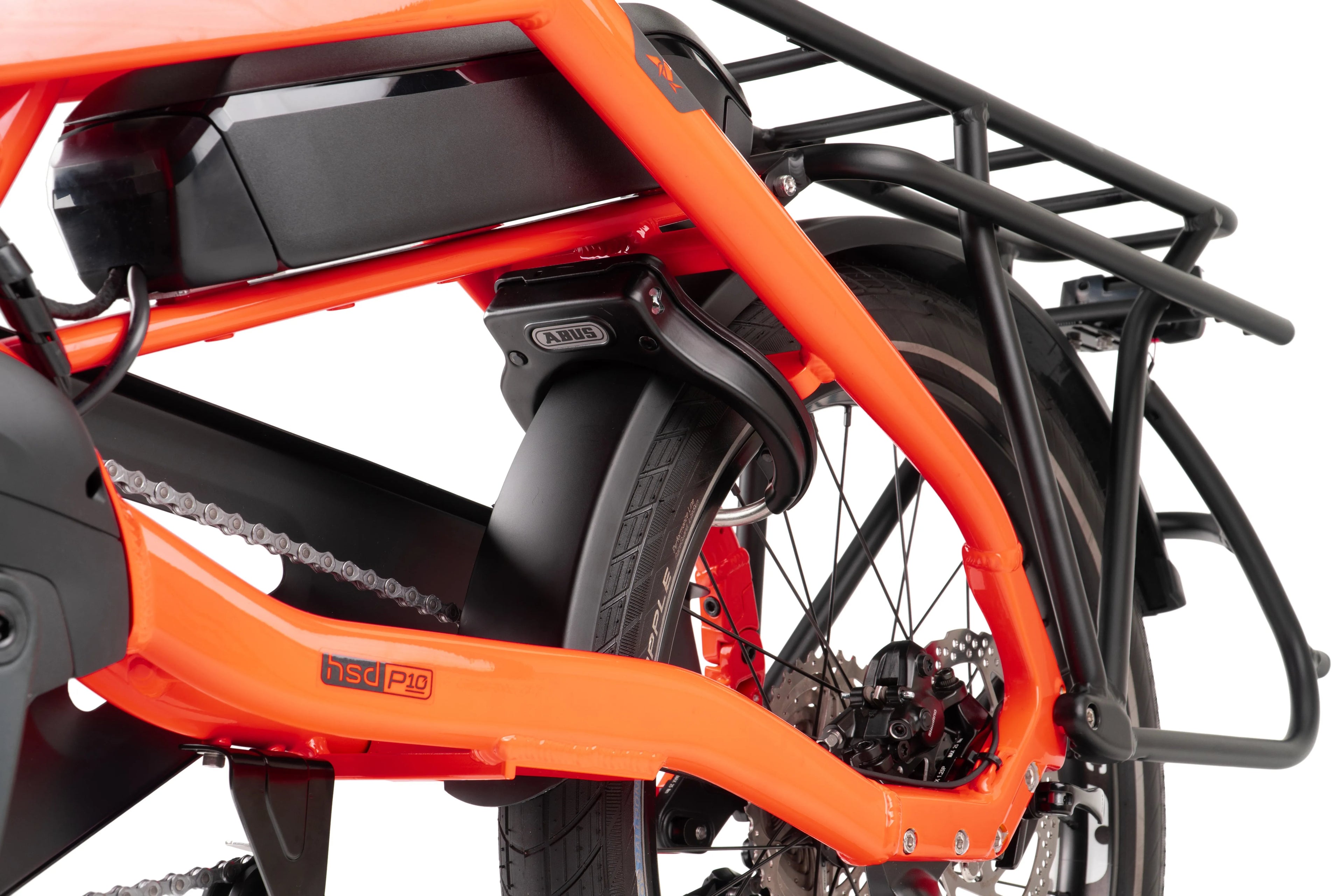 Close-up of an orange electric bike with a black rack on a white background