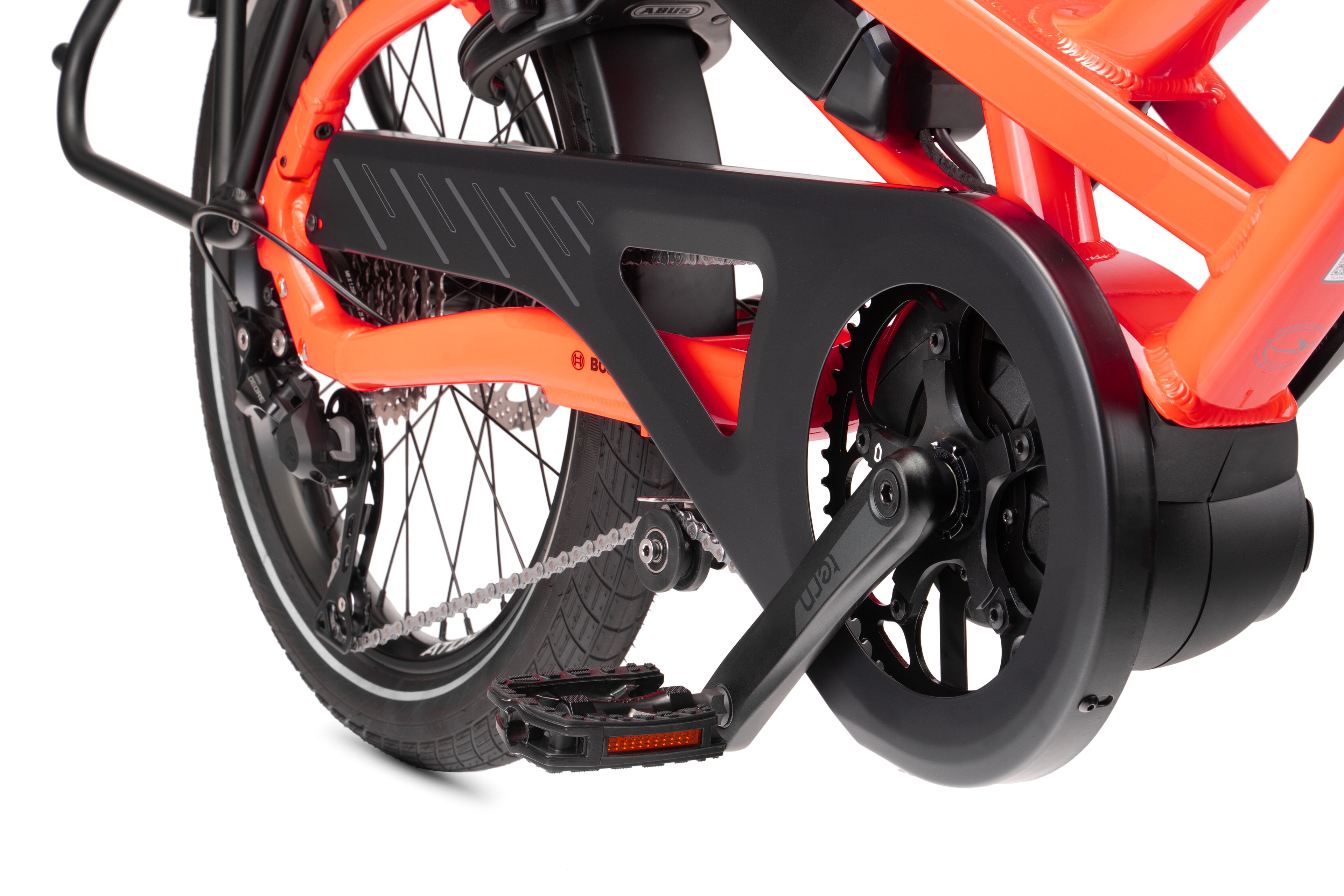 Tern cargo bike close-up of the cranks and the orange frame.