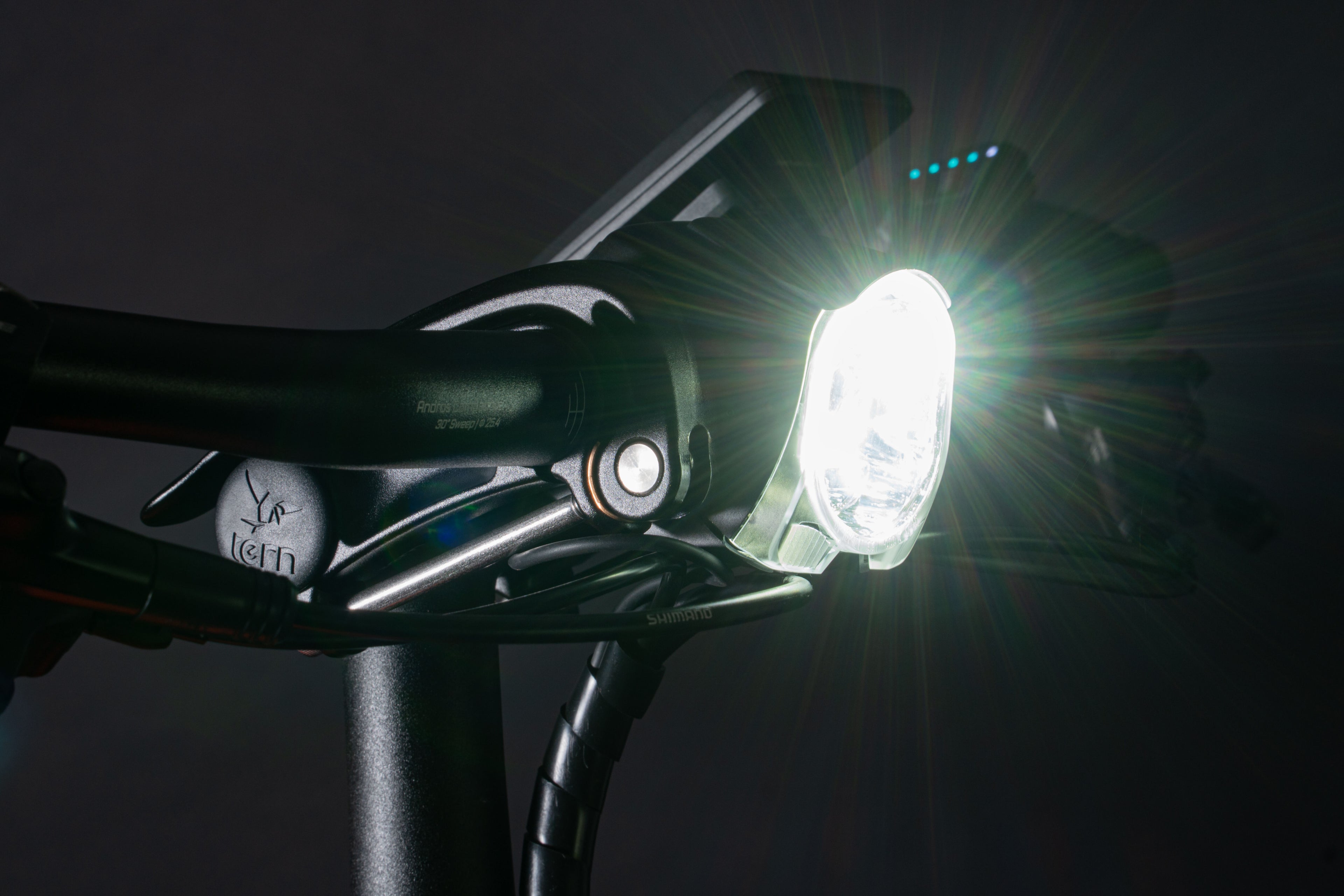 Bicycle headlight attached to a bike handlebar in a dark setting
