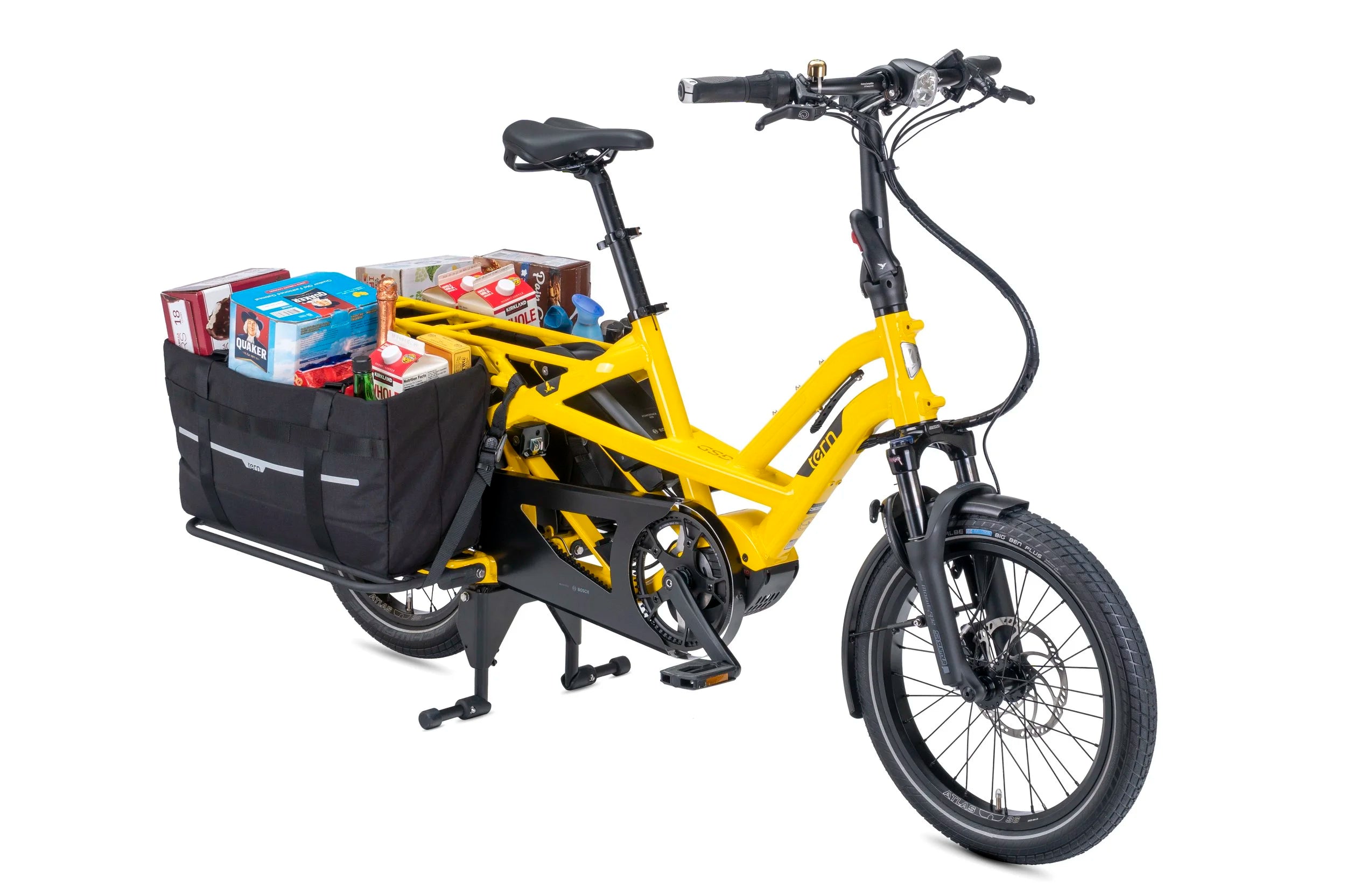 Yellow electric bike with a black basket filled with groceries on a white background