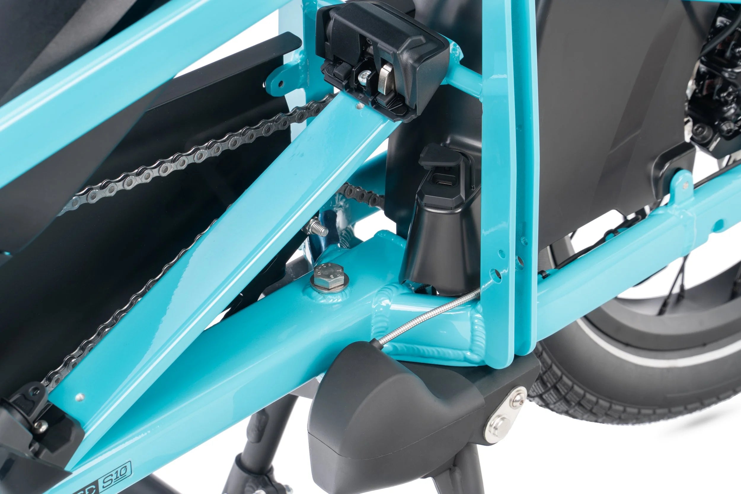 Close-up of a blue electric bike frame with chain and gears.