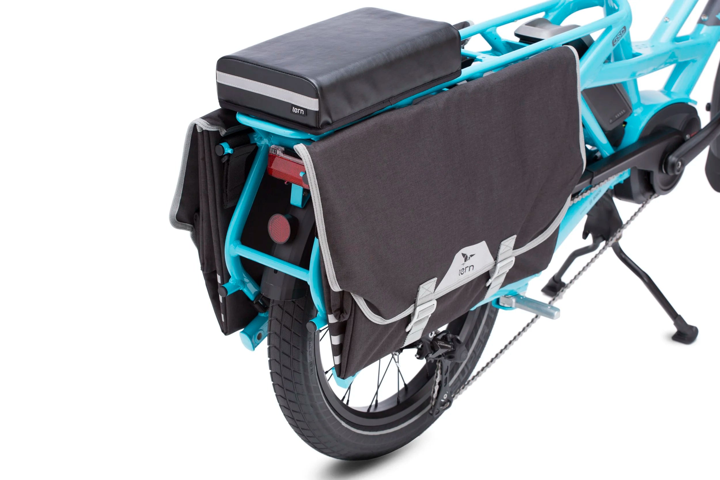 Blue cargo bike with black storage bag on a white background