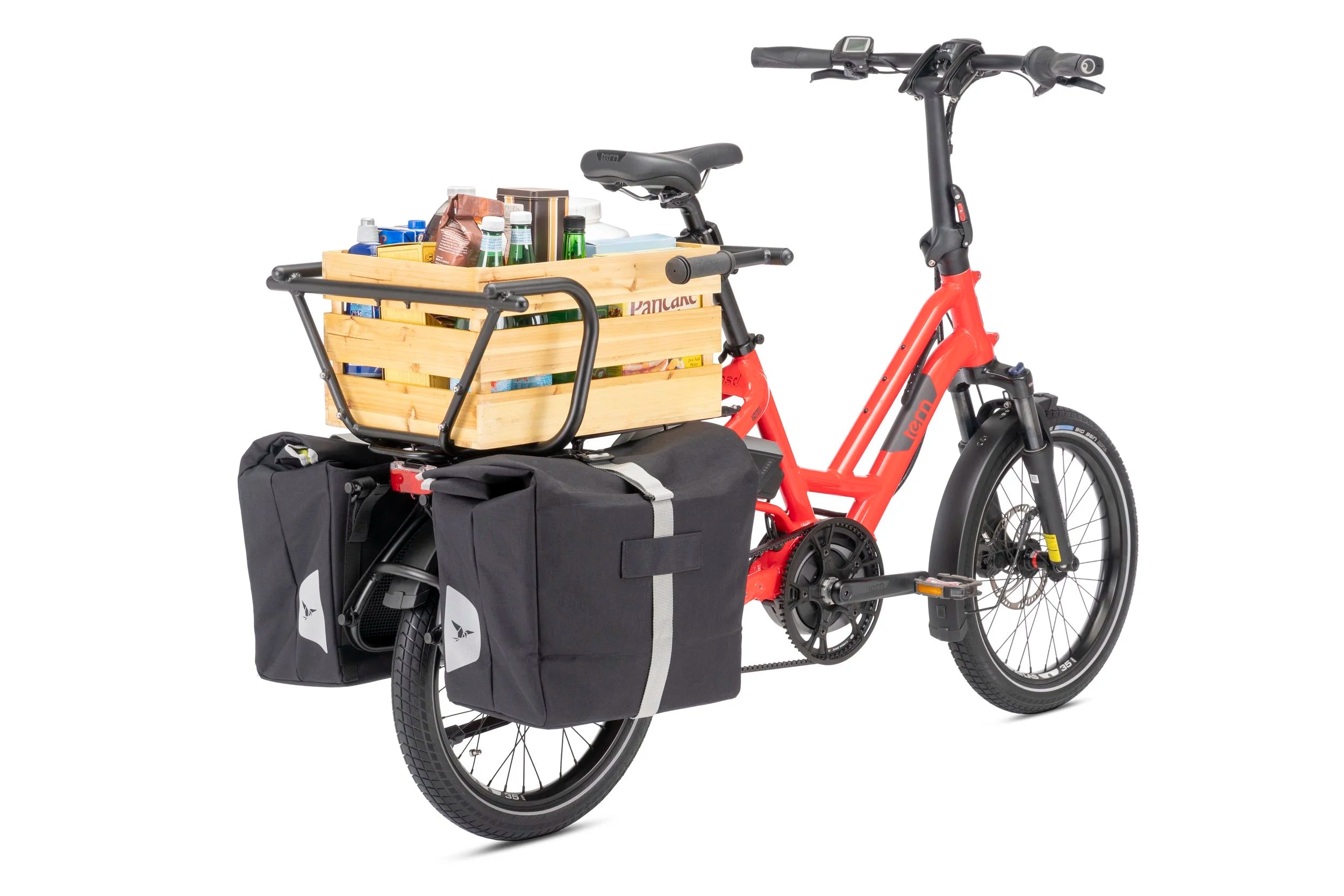 Red cargo bike with a wooden basket and black panniers on a white background