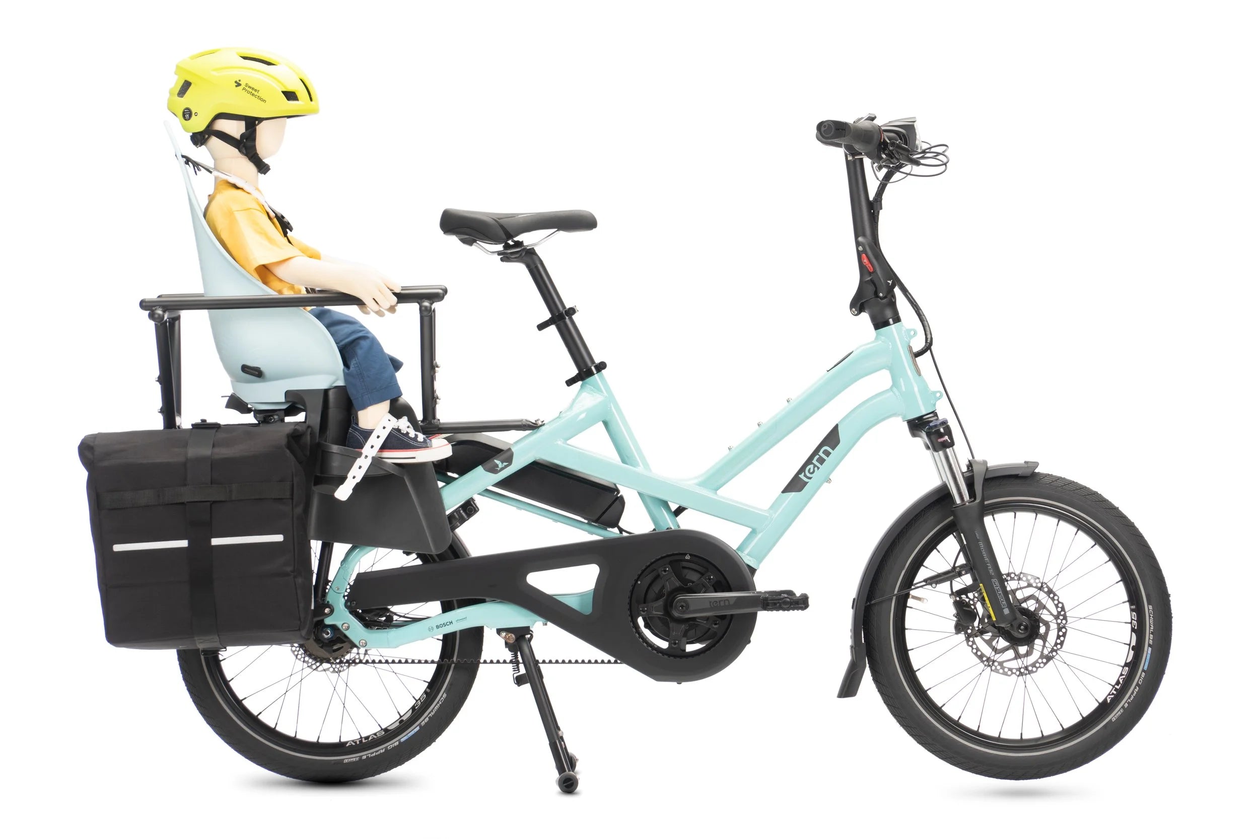 Light blue cargo bike with a child seat and helmet on a white background