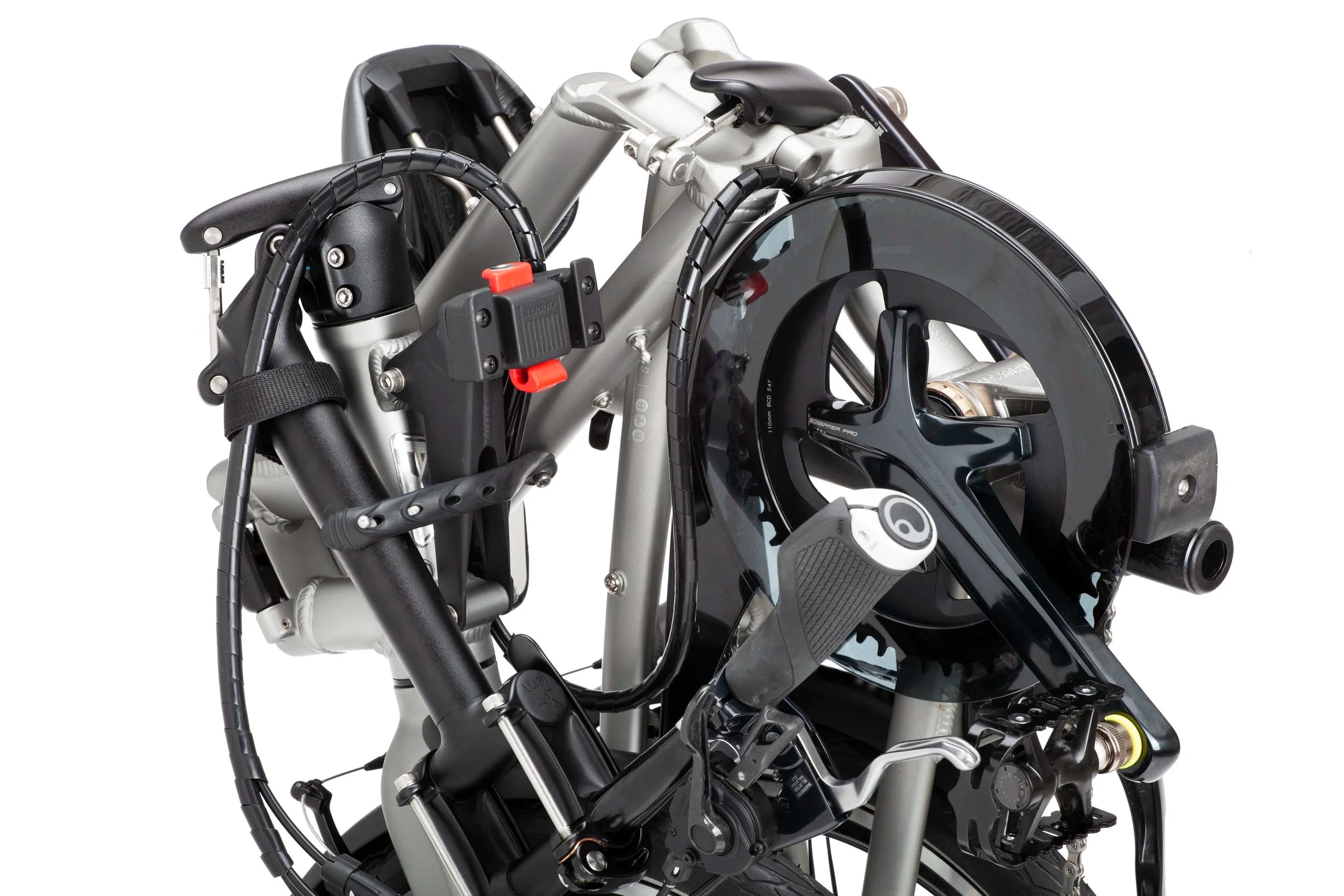 Close-up of a folded bicycle with visible mechanical components on a white background