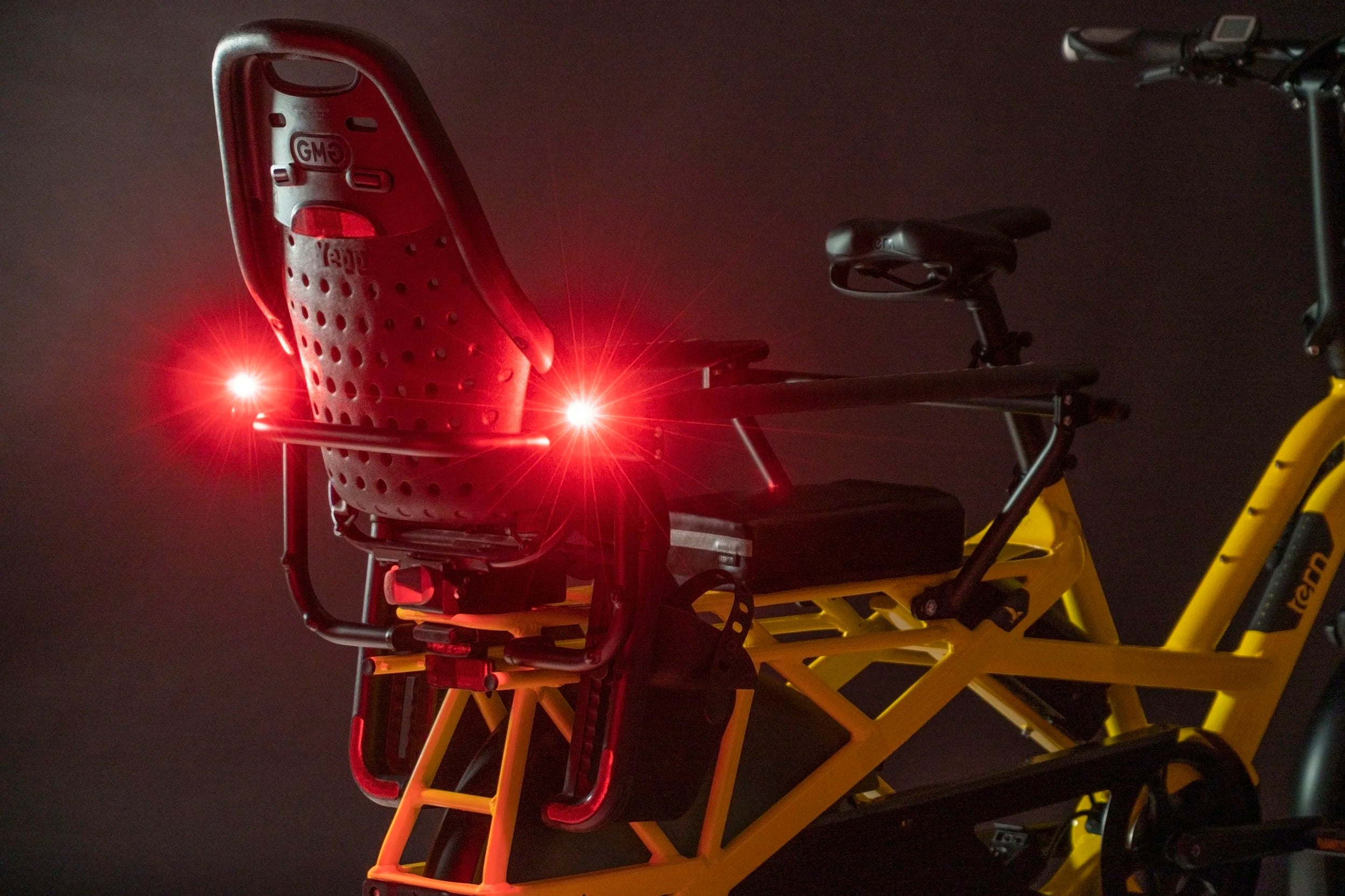 Bicycle with a red light attached to the seat on a dark background