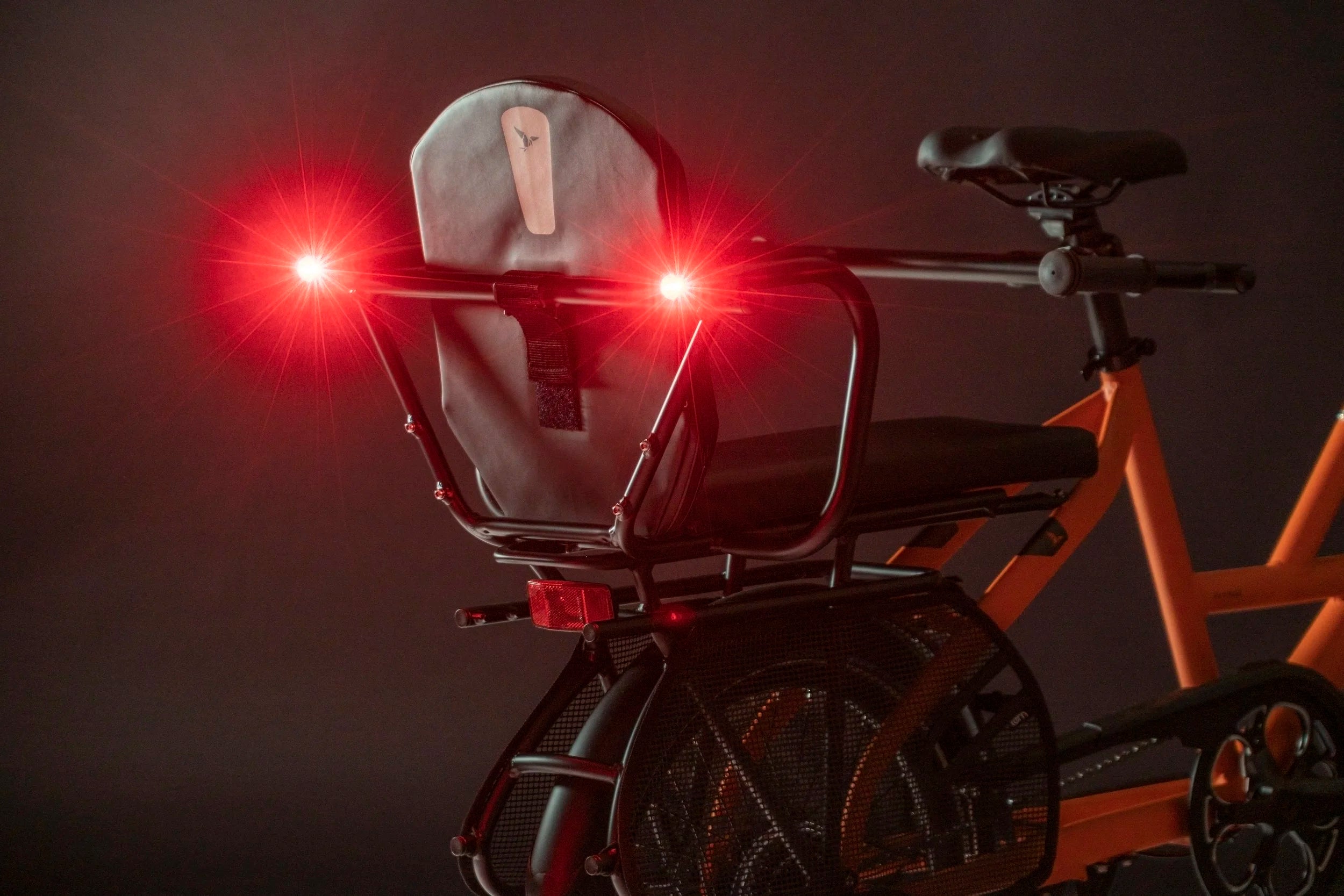Bicycle with a rear light attached on a dark background