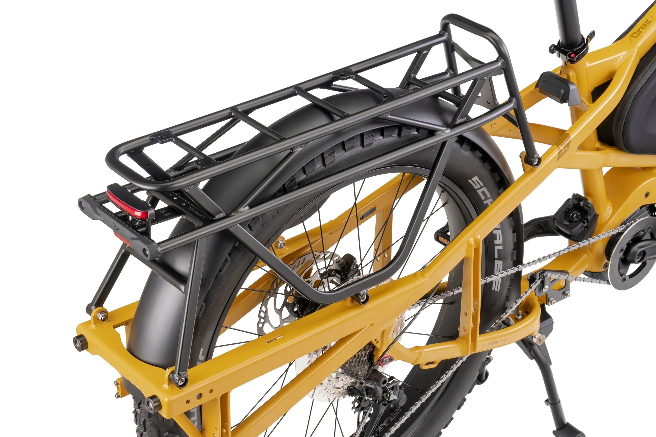 Yellow bicycle with a black rear rack on a white background