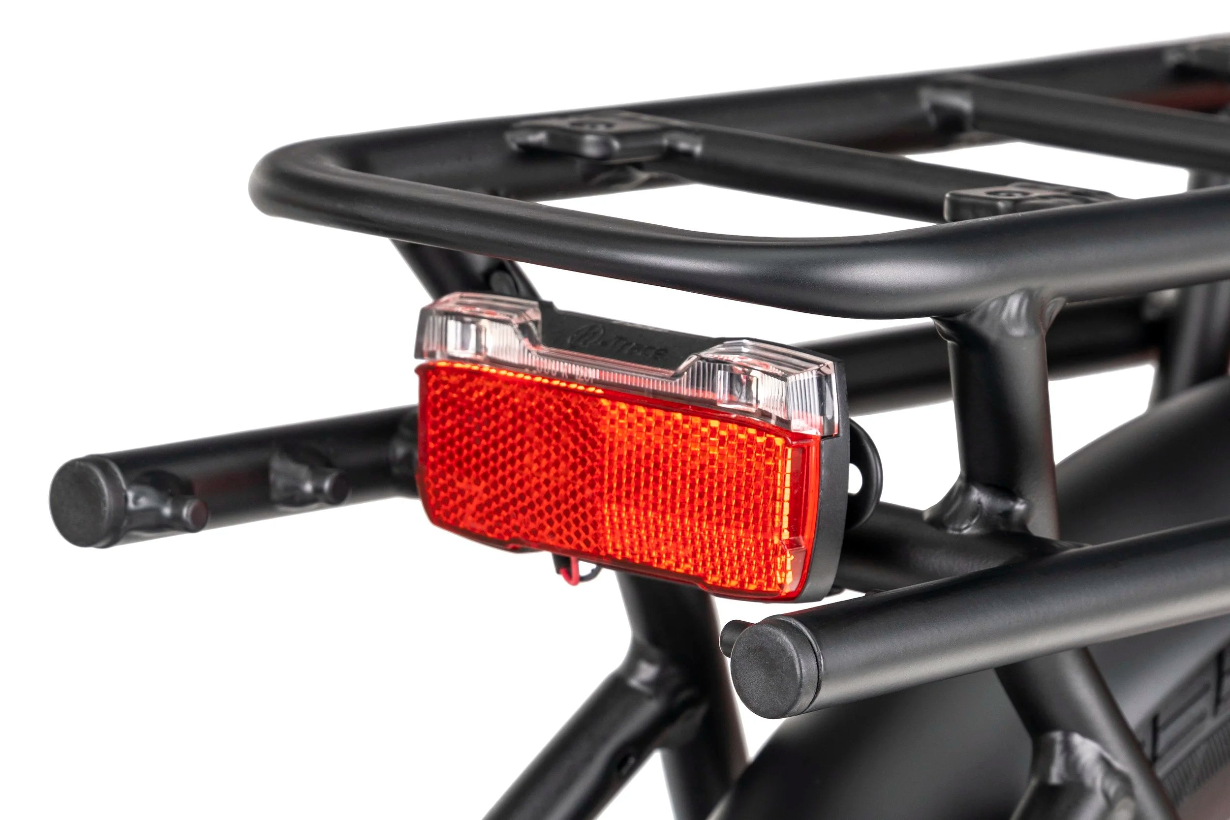 Bicycle taillight attached to a bike rack on a white background