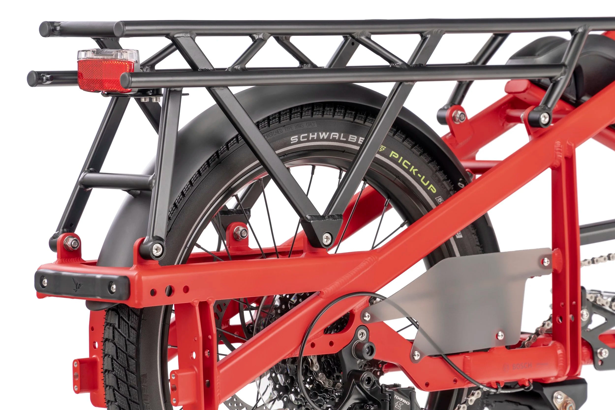 Close-up of a red Cargo bicycle with a black tire and visible brand name on a white background