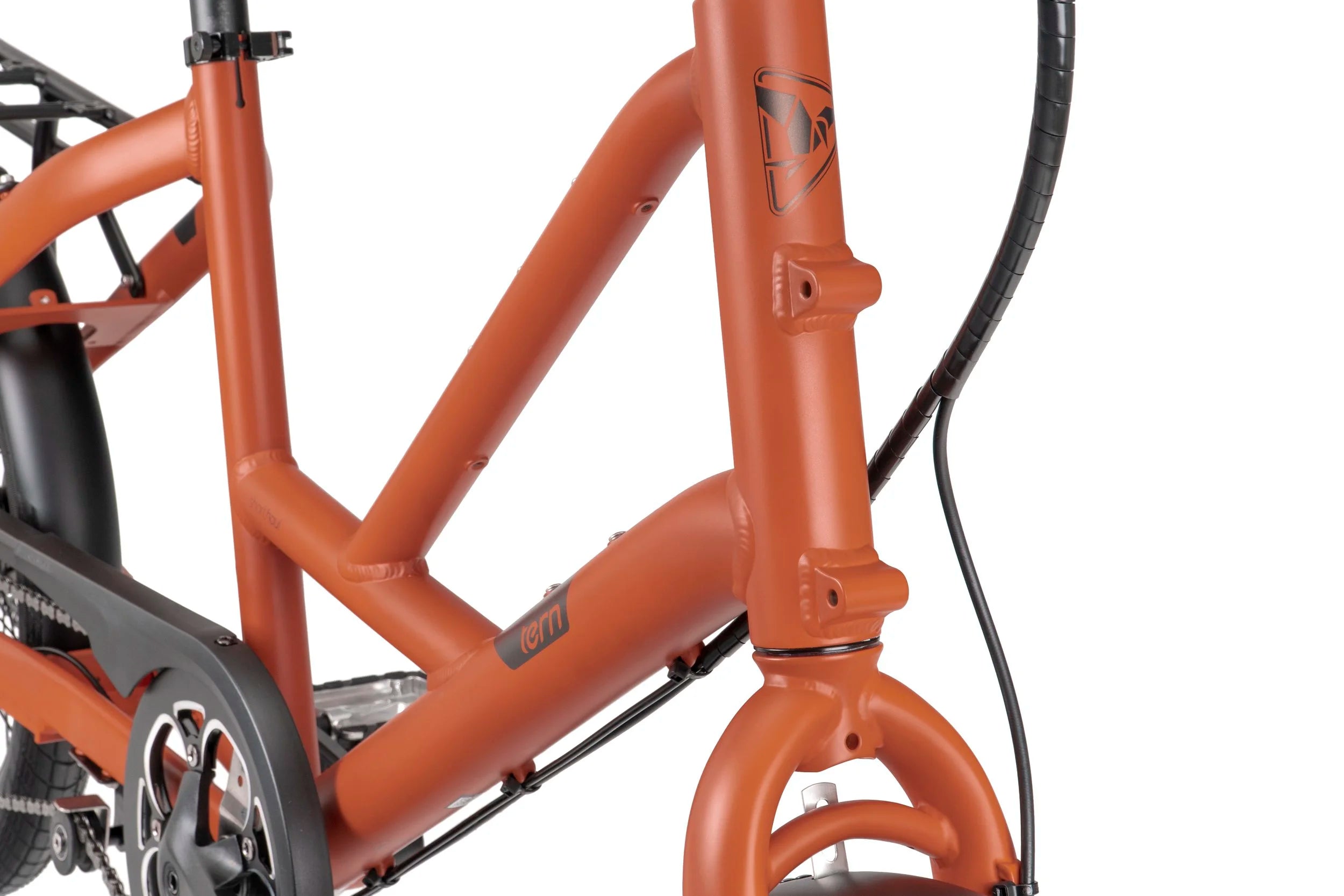 Close-up of a red bicycle frame with visible 'Tern' branding on a white background