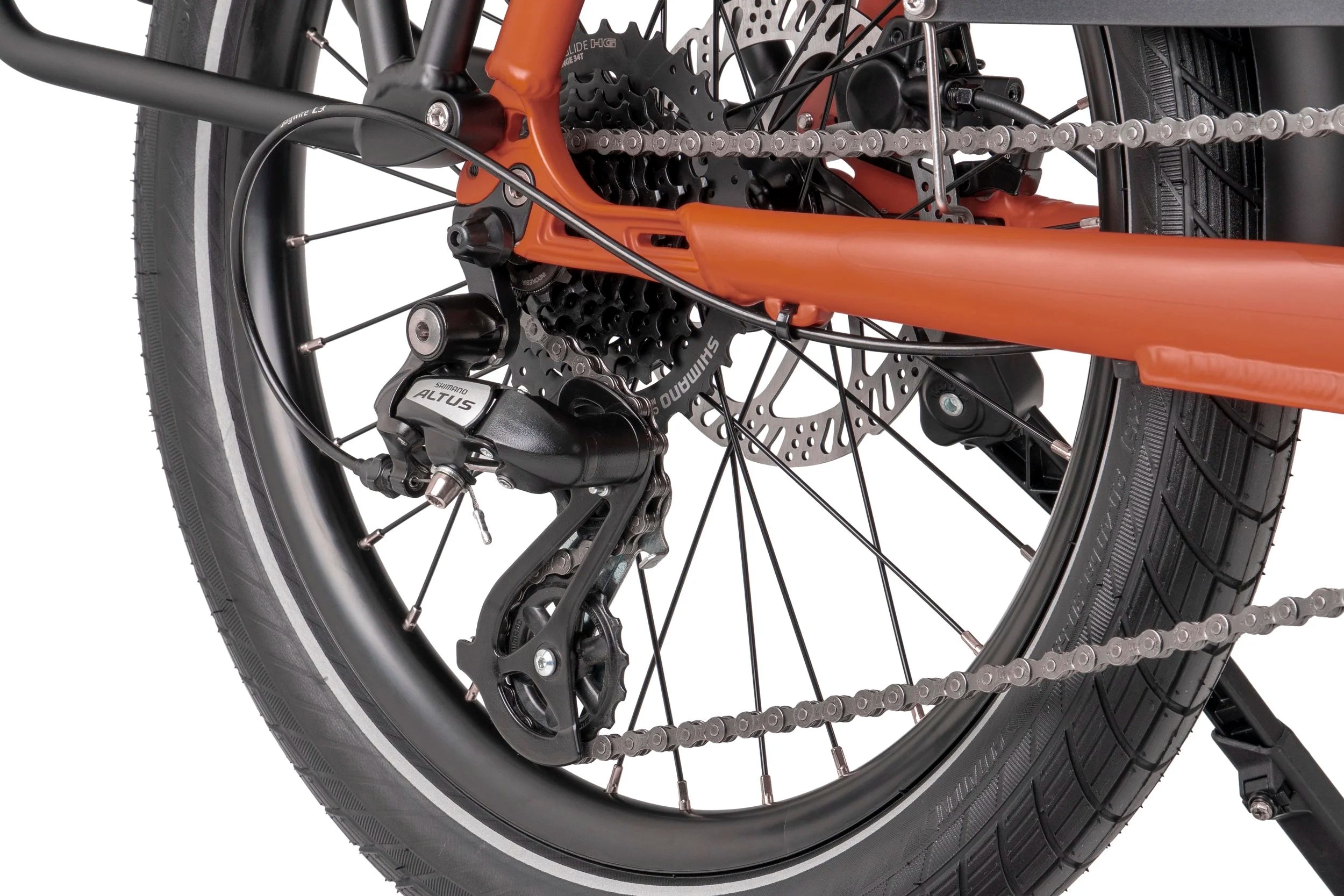 Close-up of a Tern bicycle rear wheel with chain and gear system on a white background